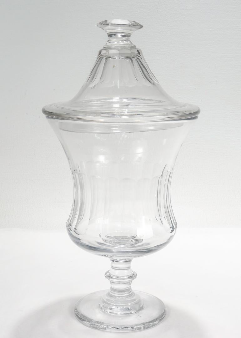 A fine antique English cut glass jar.

With a blown body & top with cut panels to the side.

Supported by pedestal with an applied knop & wafer foot.

Simply a wonderful lidded glass container!

Date:
Late 19th or early 20th Century

Overall