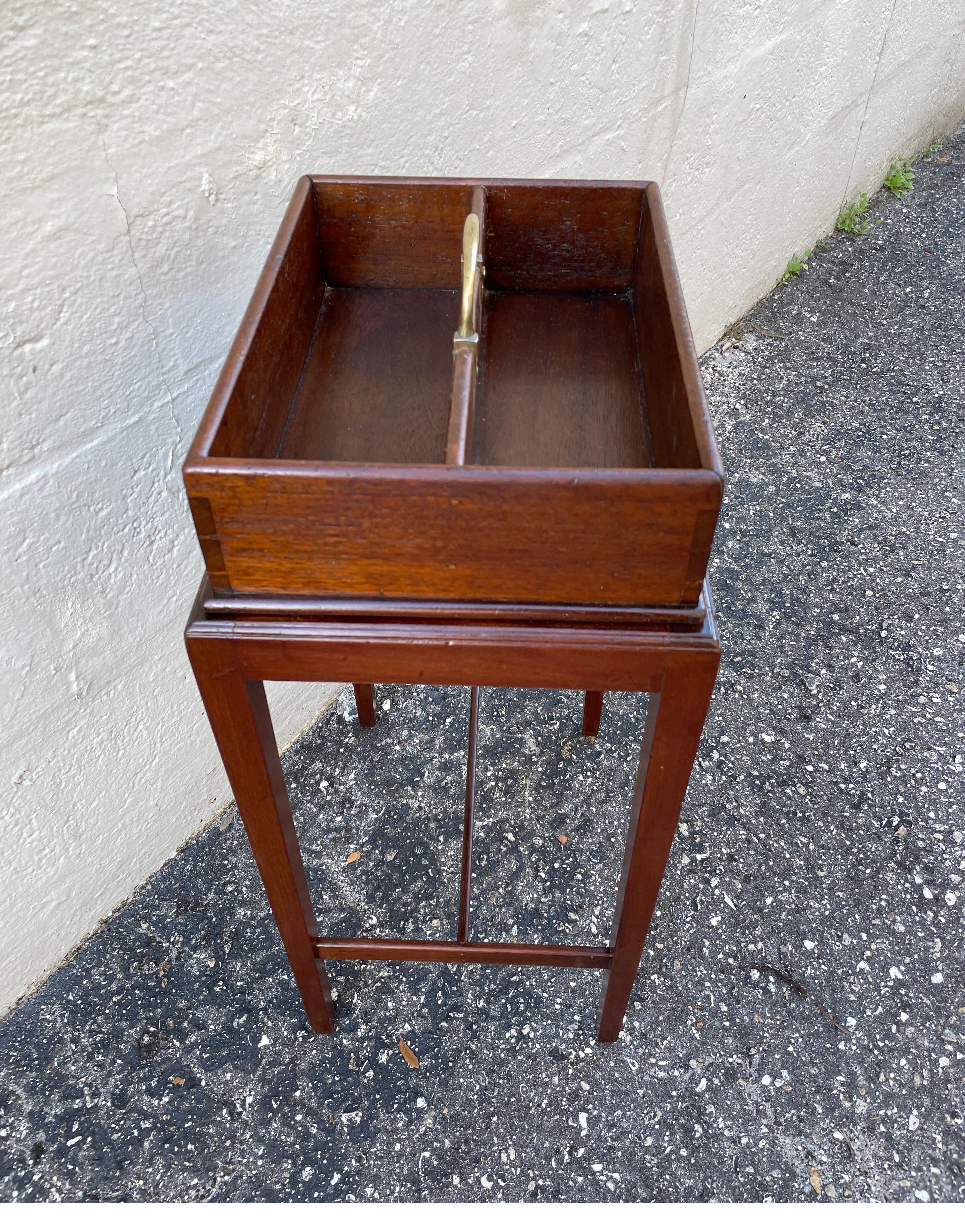 Antique box on stand with brass handle.