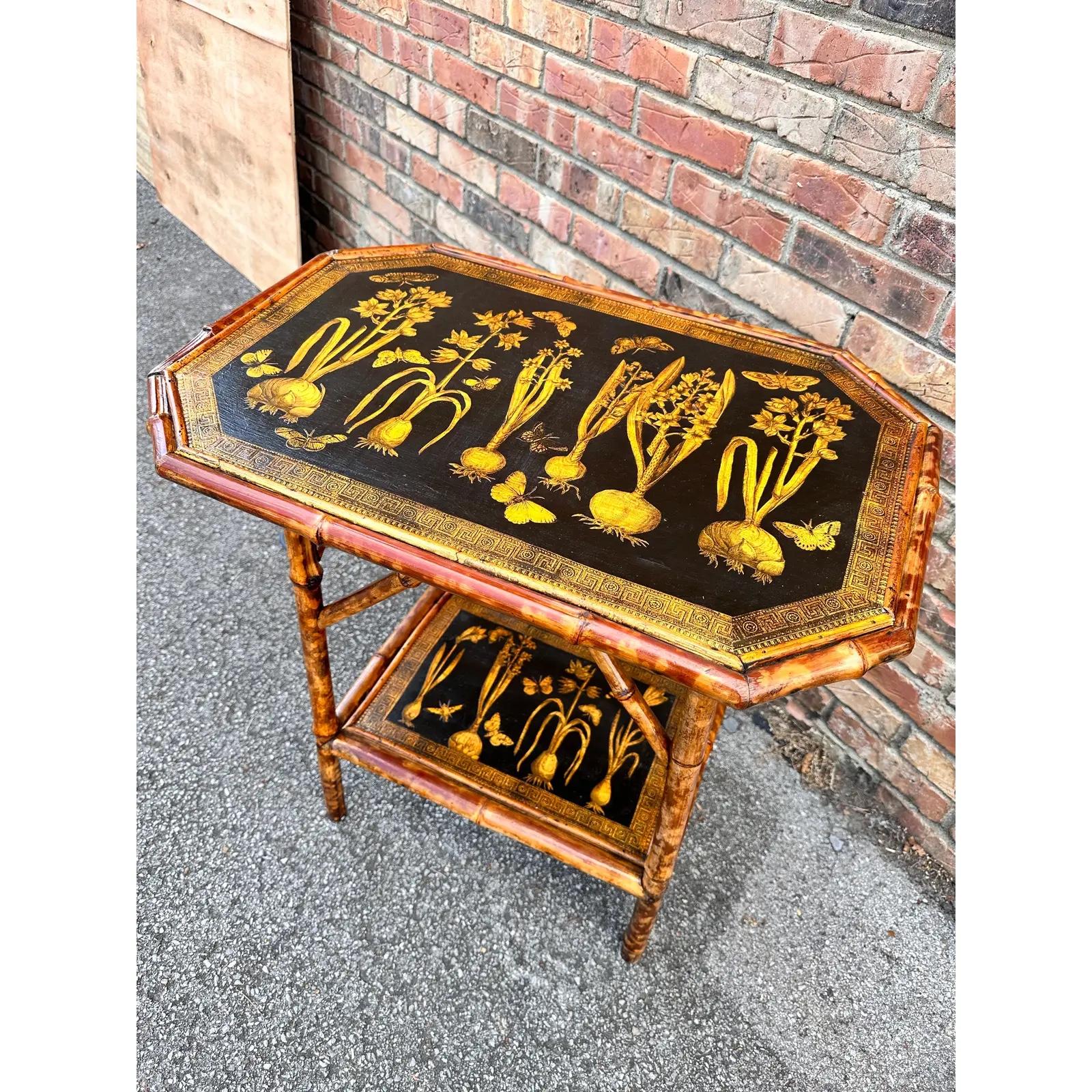 This is a beautiful antique English bamboo table. It’s been beautifully decapodged with antique botanical prints. The hello golden rod color and the black looks so amazing together. 
