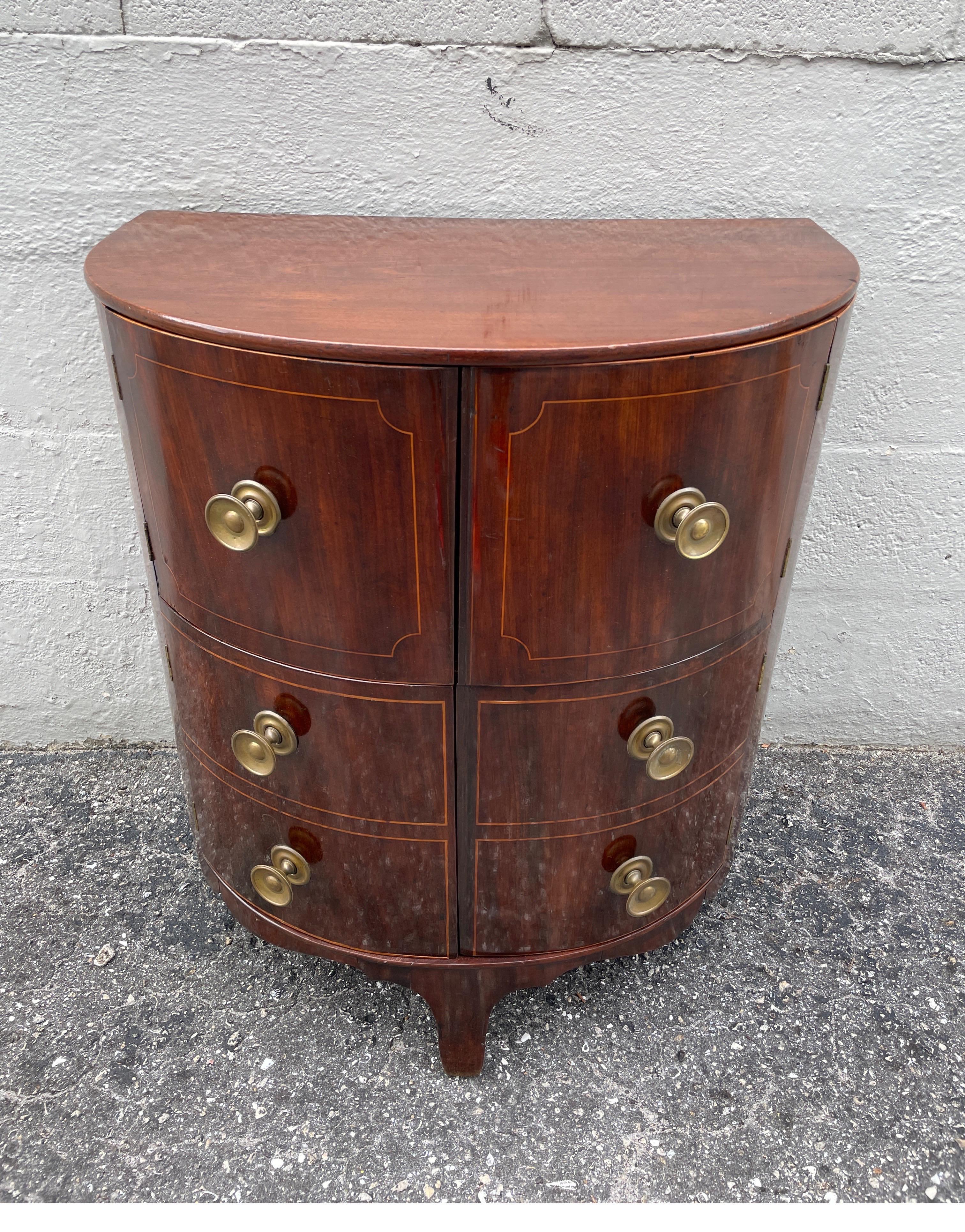 Antique demi lune cabinet with doors that open to two interior shelves. Top is hinged to open up & back. Would make a great dry bar. Wonderful & unique piece.