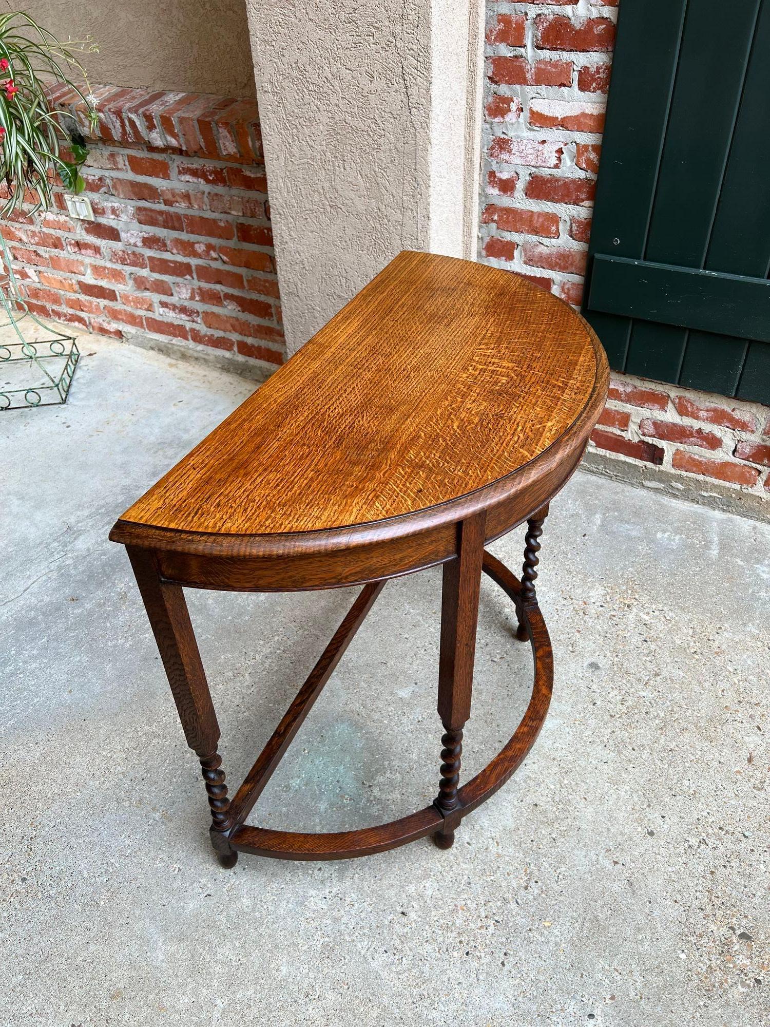Antique English Demilune Console Hall Table Barley Twist Oak c1940.

Direct from England, a lovely British console table with a demilune or “half moon” shape.
Classic English style with a beveled edge oak tabletop over the wide, curved apron. Four