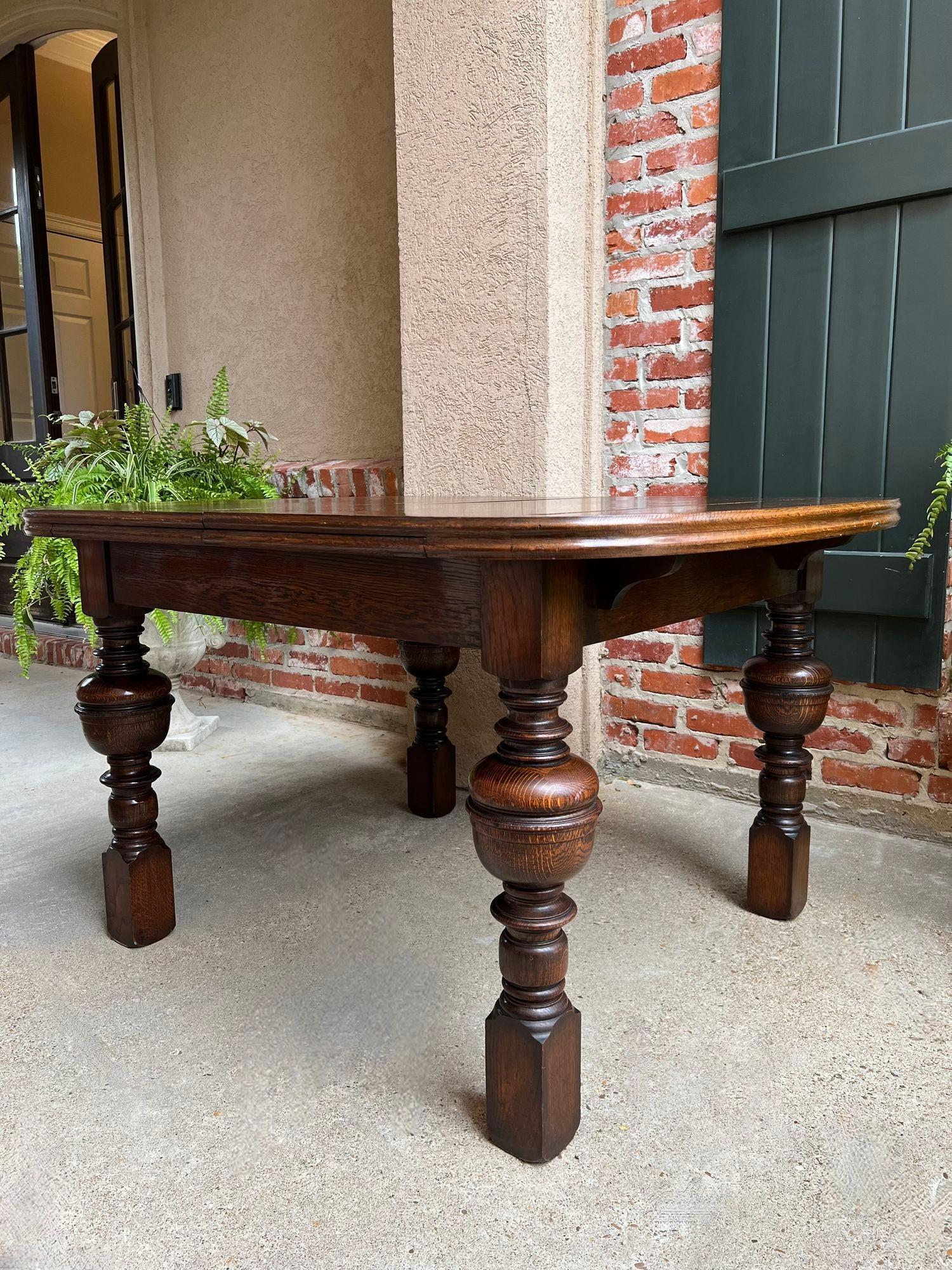 Antique English Dining Table Draw Leaf Tudor Carved Tiger Oak Large Game Kitchen.

Direct from England, a beautiful antique draw leaf table that expands to over 6 ft. with leaves extended!  The large, rounded tabletop features outstanding tiger oak