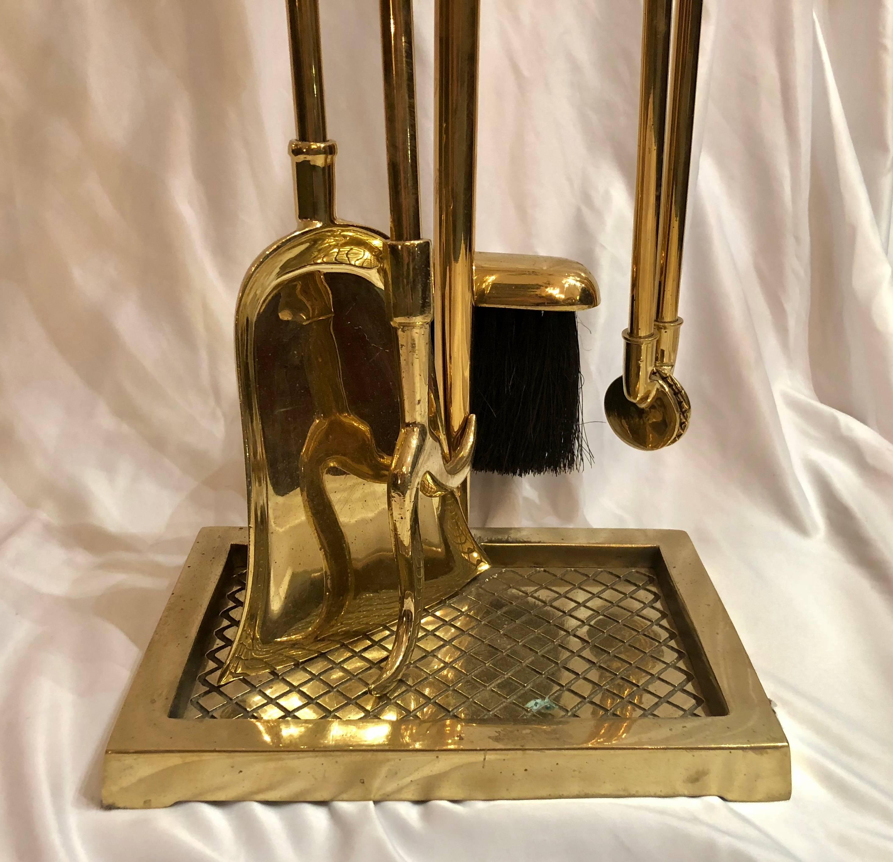Antique English dolphin brass tool set in stand.