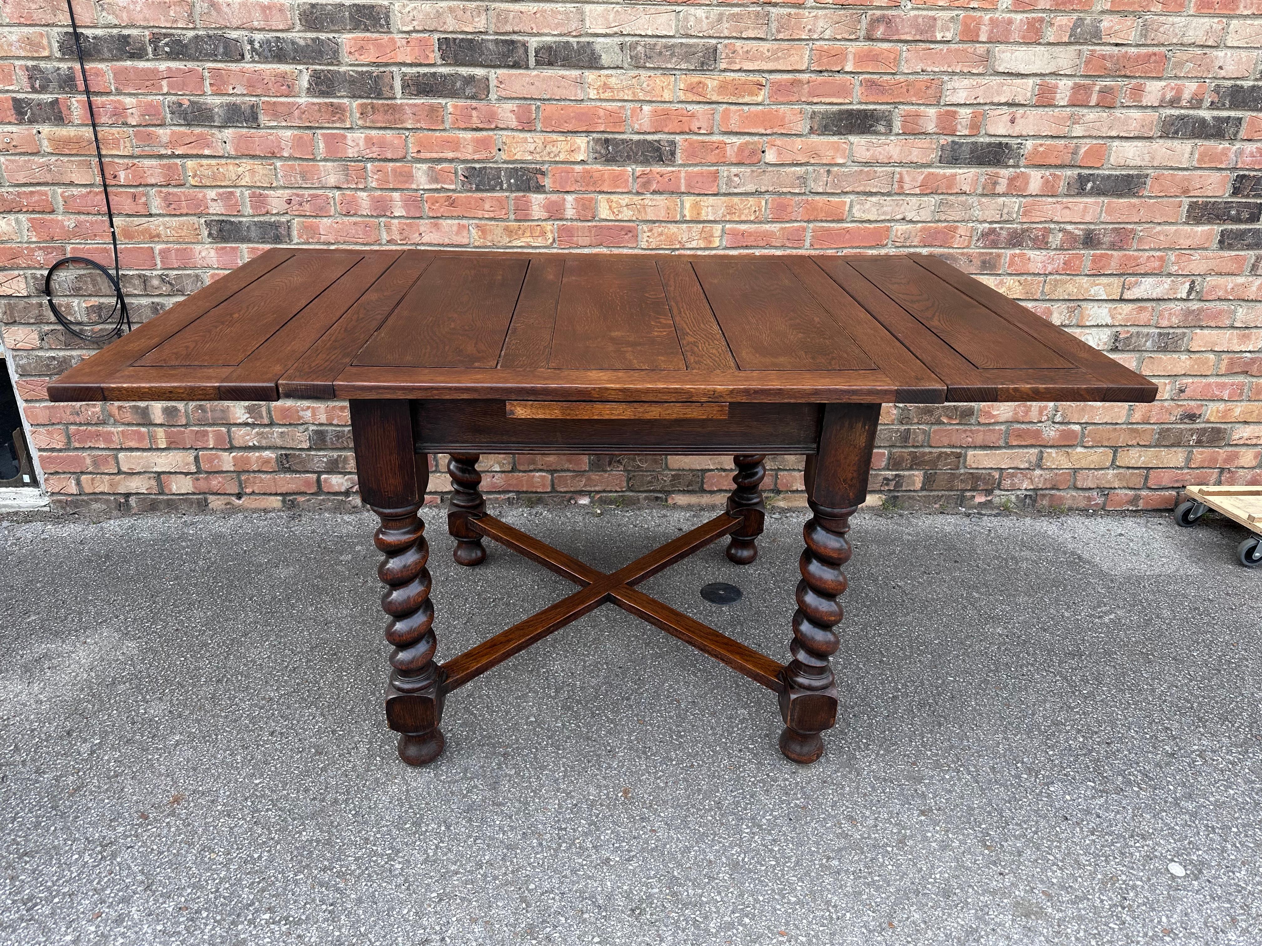 This is a great little English game table/draw leaf table measures 60' with both leafs extended. The wood is dark oak the legs are a beautifully turned barley twist with nice age and patina.These tables are very versatile and offer many uses from