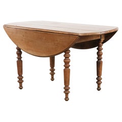 Antique English drop-leaf dining table made of walnut with elegant legs