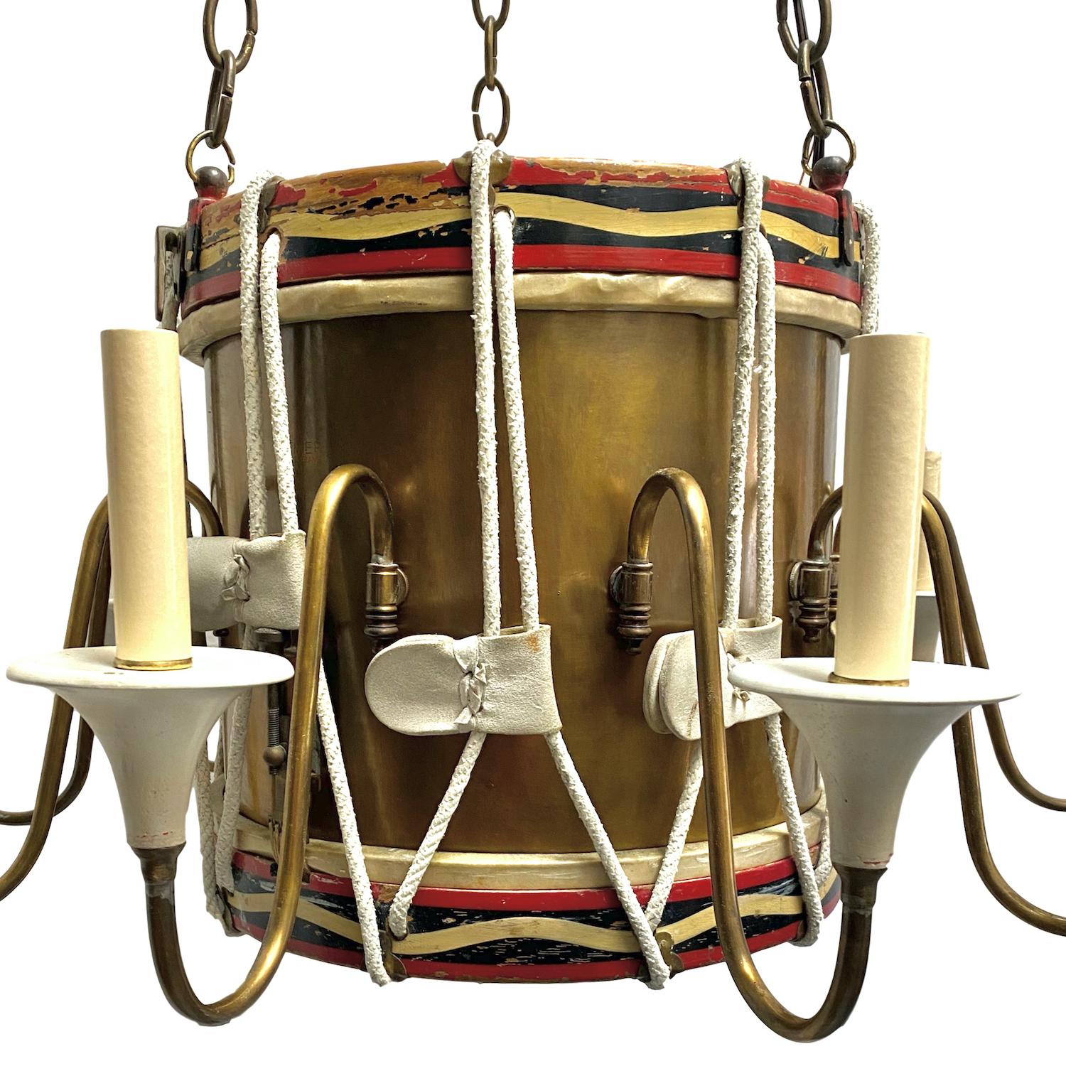 A circa 1940s English 10-arm brass and wood drum chandelier with original painted finish and patina.

Measurements:
Current drop (adjustable) 42