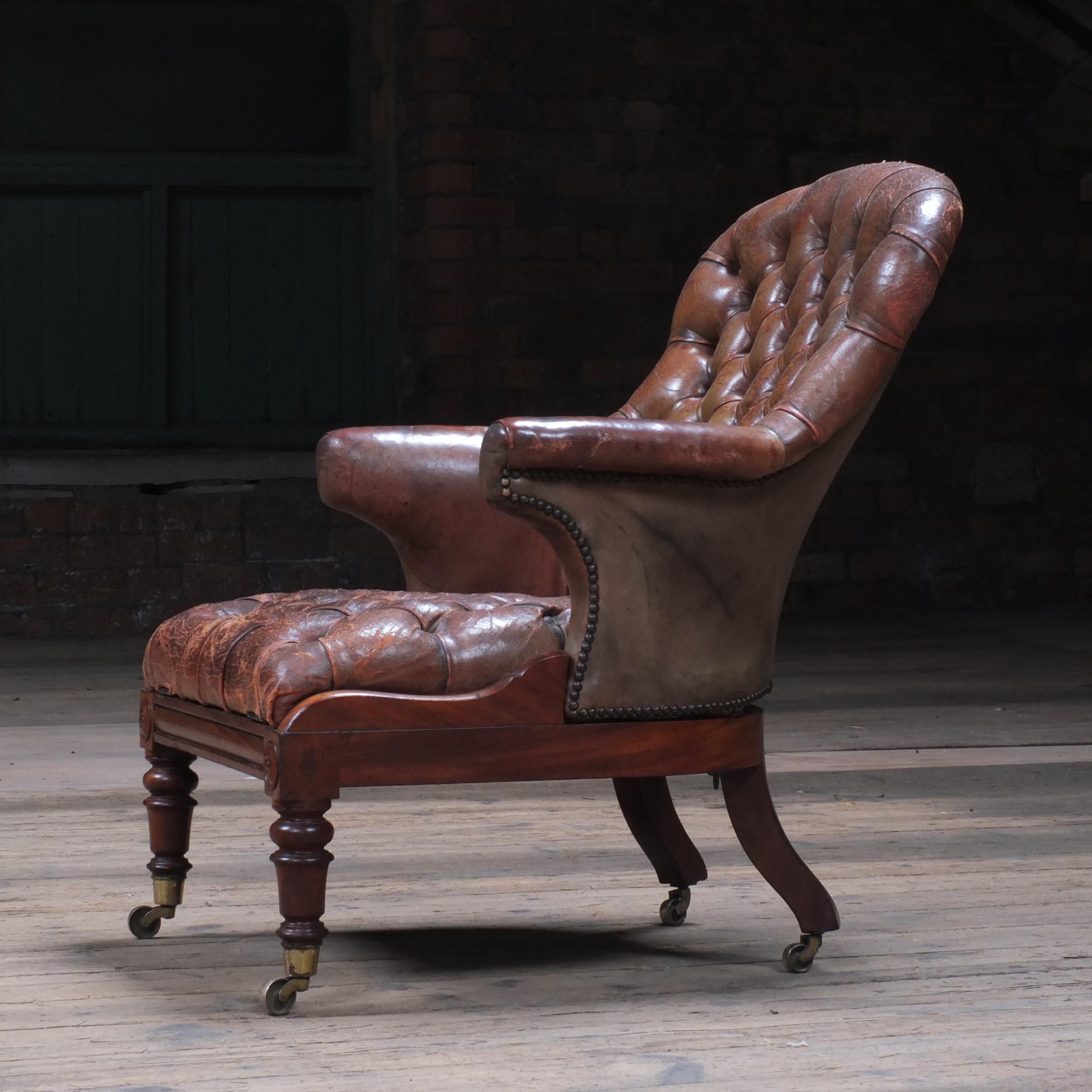 An early Victorian walnut and leather armchair. The chair seat lifts up from the back and hinges forward at the front, the back also reclines slightly. I must admit I'm not too sure why the chair functions this way and could be some sort of fix to a