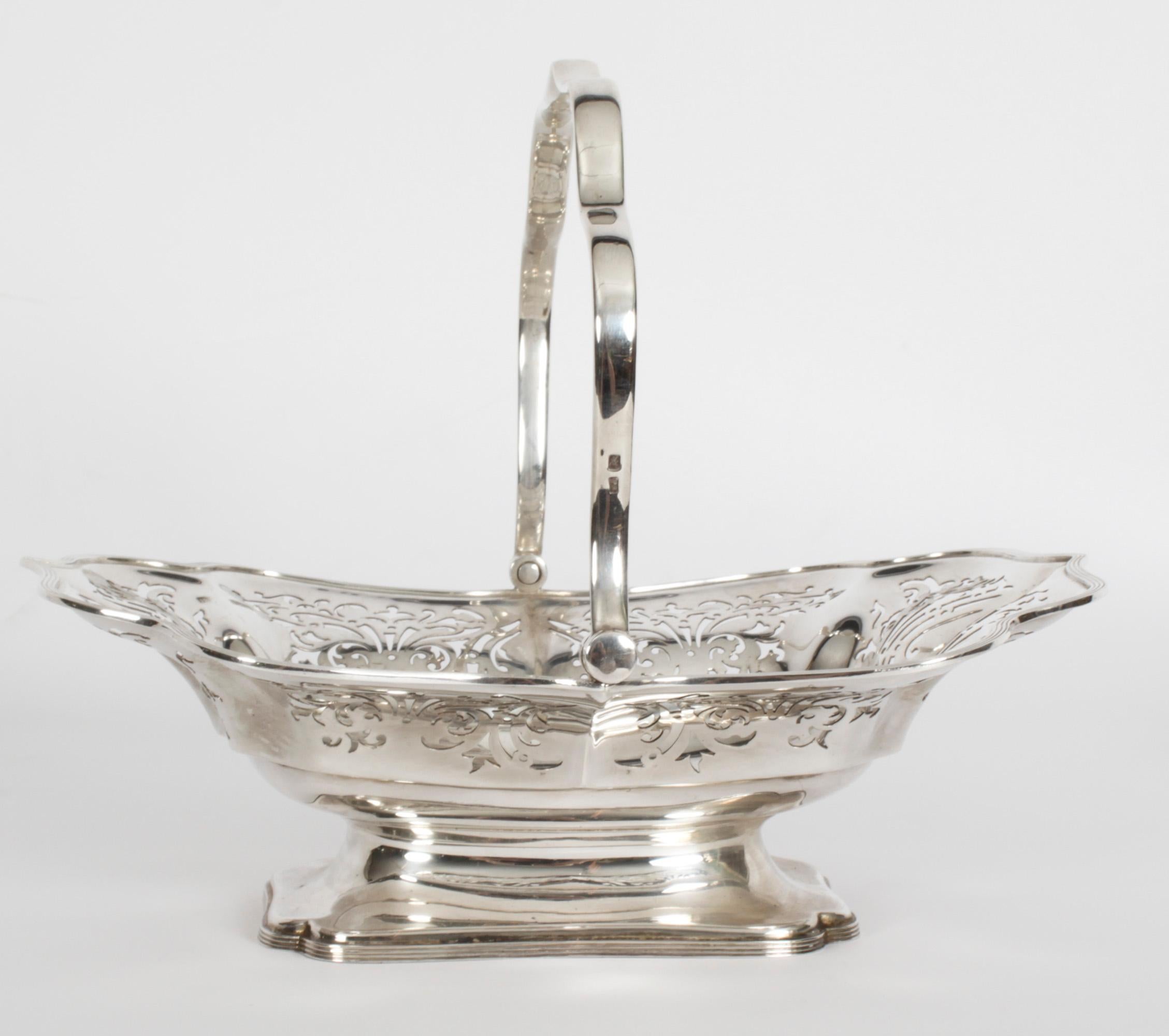 This is an exceptionally fine antique English Edwardian sterling silver fruit basket with hallmarks for Sheffield 1907 and the maker mark of Atkin Brothers.

This magnificent basket has a shaped swing handle on flared shaped oblong basket and