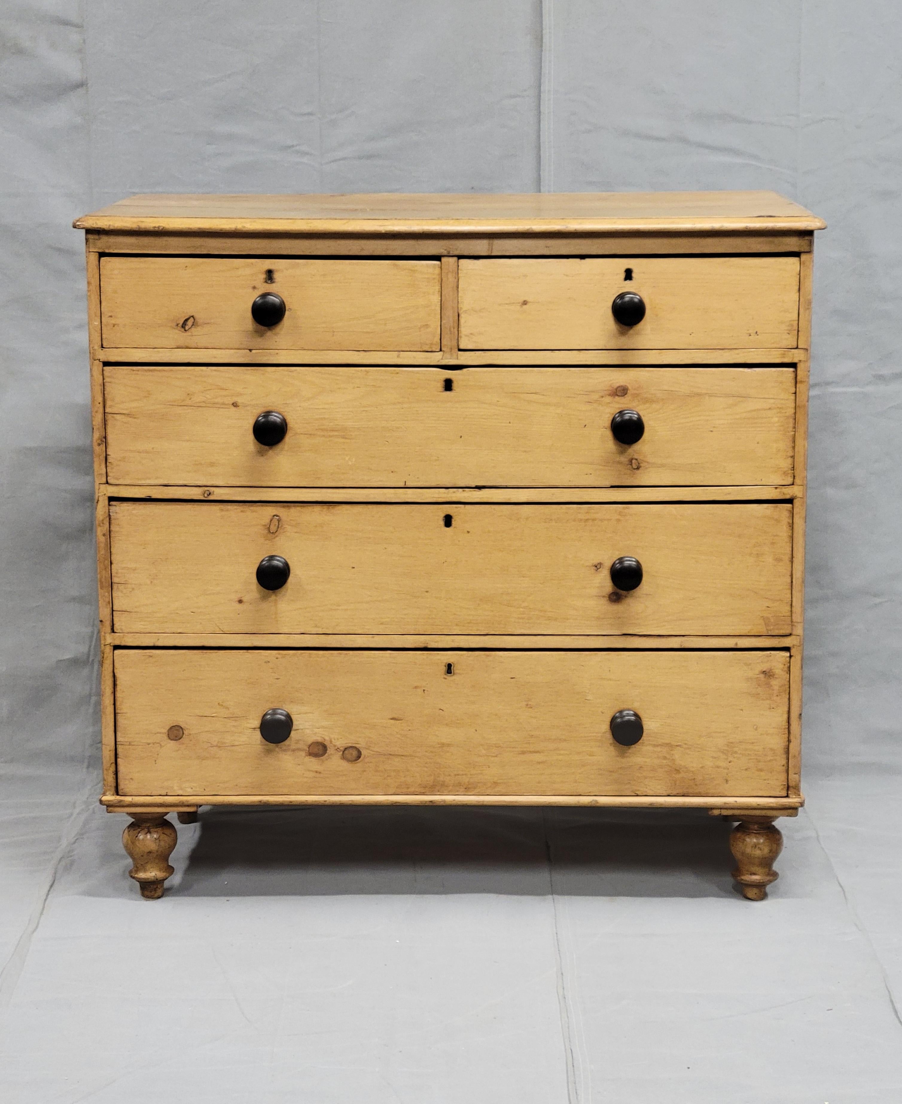 This Antique English Edwardian chest of drawers made of scrubbed pine sits on turnip feet and is a unique addition to your home decor. The dresser has 5 spacious drawers that can hold all your essentials, and its 41in length, 40in height, and 20in
