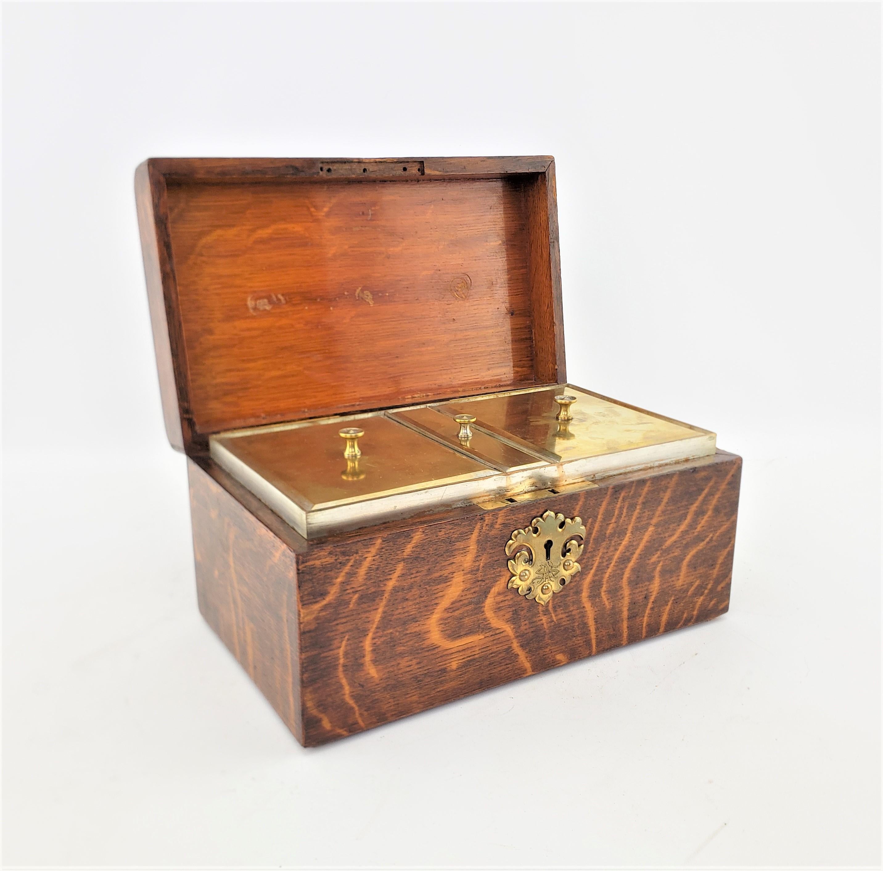 This antique tea caddy has no maker's marks, but presumed to have originated from England and date to approximately 1900 and done in a period Edwardian style. The outer case of the tea caddy is composed of what I believe to be fumed oak with a