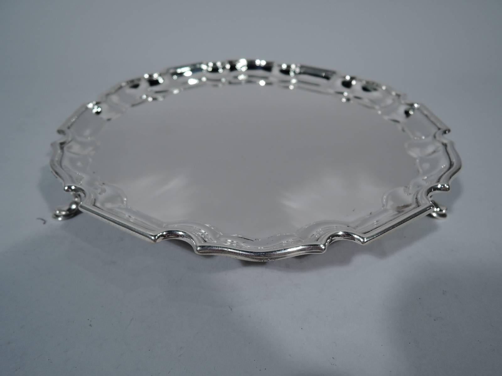 Edwardian Sterling Silver Salver. Made by Goldsmiths & Silversmiths, Ltd in London in 1905. Circular with molded curvilinear piecrust rim. Rests on 3 padded c-scrolls. Sweet Georgian revival. Hallmarked. Weight: 9.5 troy ounces.
