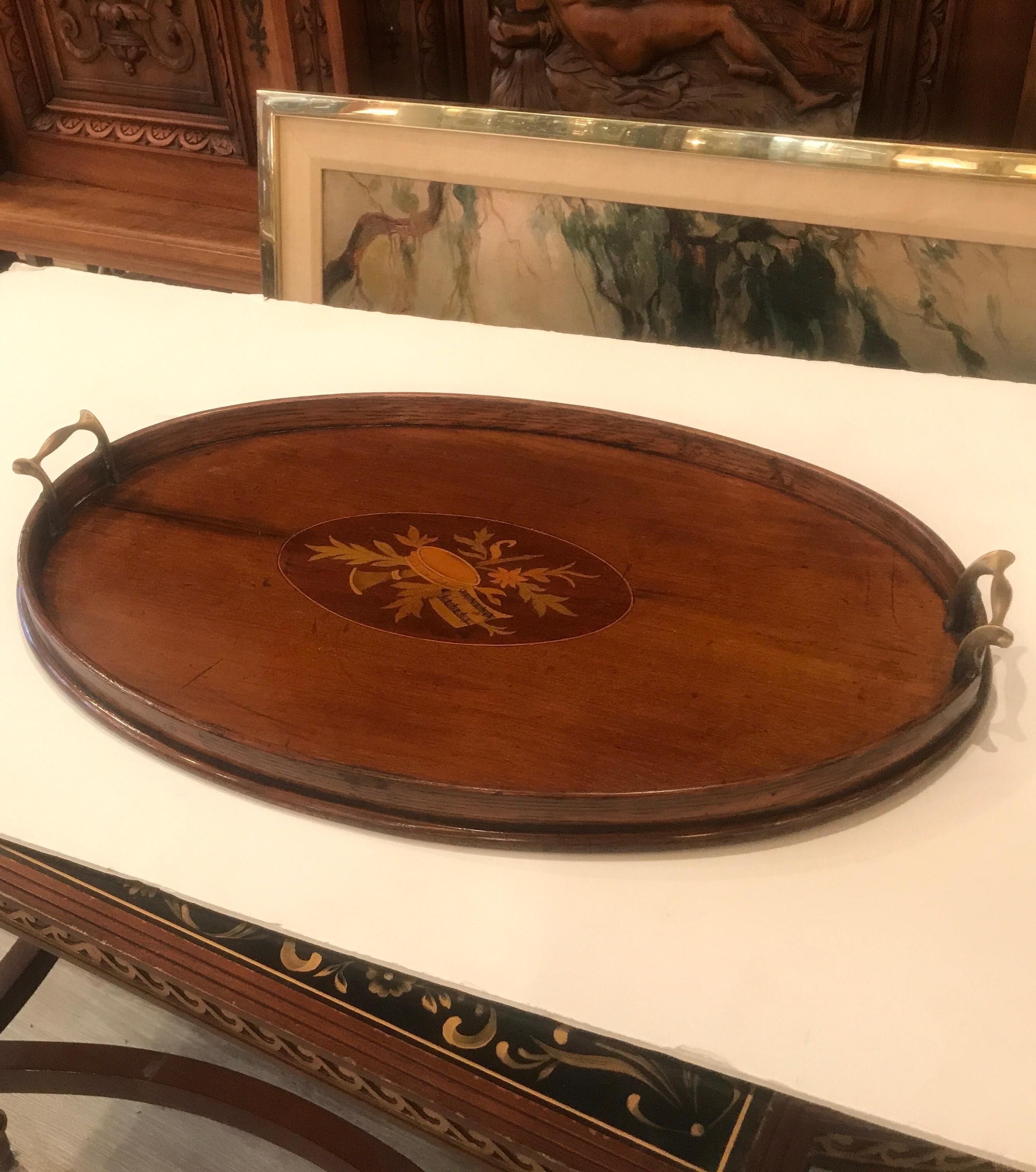Elegant Edwardian English serving tray with inlaid cartouche. The wood gallery edge with brass handles, England Circa 1905.