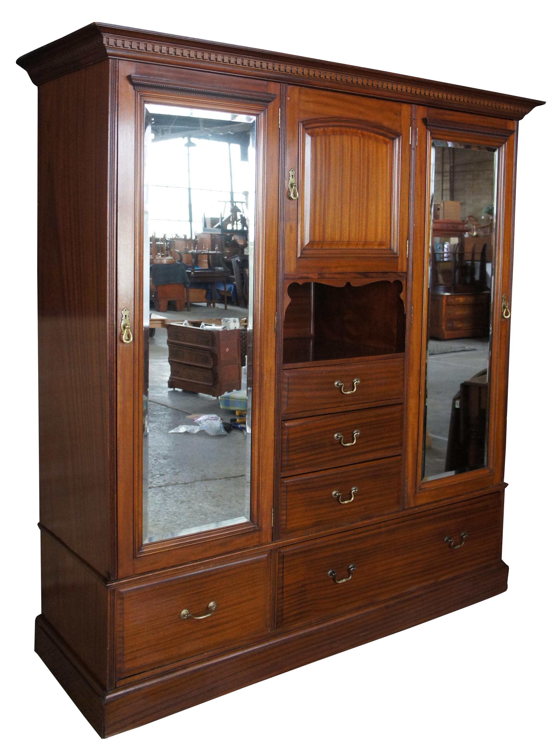 Antique English Edwardian mahogany chifferobe wardrobe closet clothing armoire

Early 20th century mahogany chifforobe. Traditional style with two outer mirrored hanging closets. Includes four drawers, and upper cubby. Doors open via unique latch