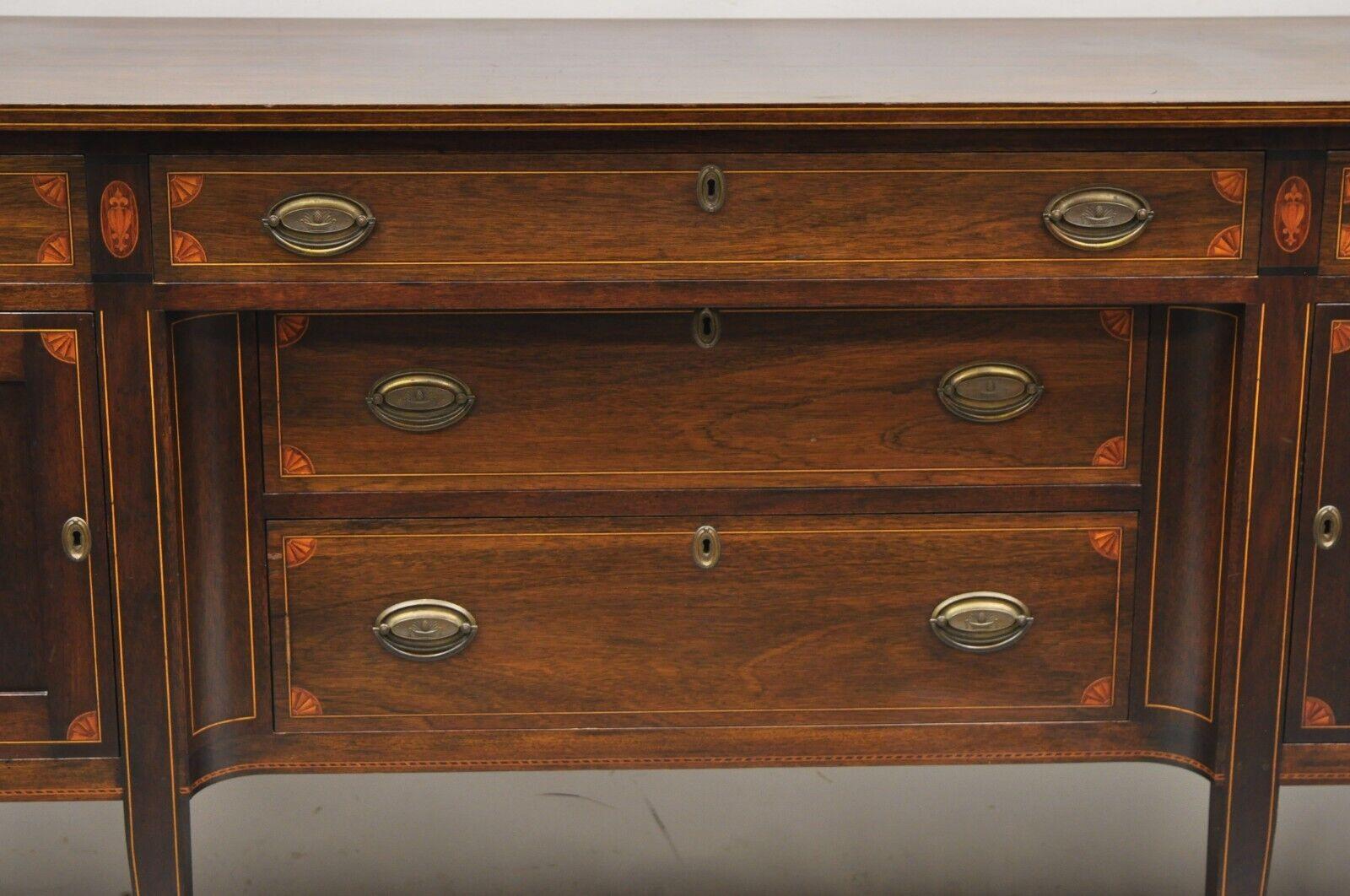 Antique English Edwardian Mahogany Sideboard Buffet with Pinwheel Inlay. Item features satinwood pencil inlay throughout, pinwheel satinwood inlay, 5 drawers, unlocked with no key, tapered legs, beautiful wood grain, 2 swing doors, quality