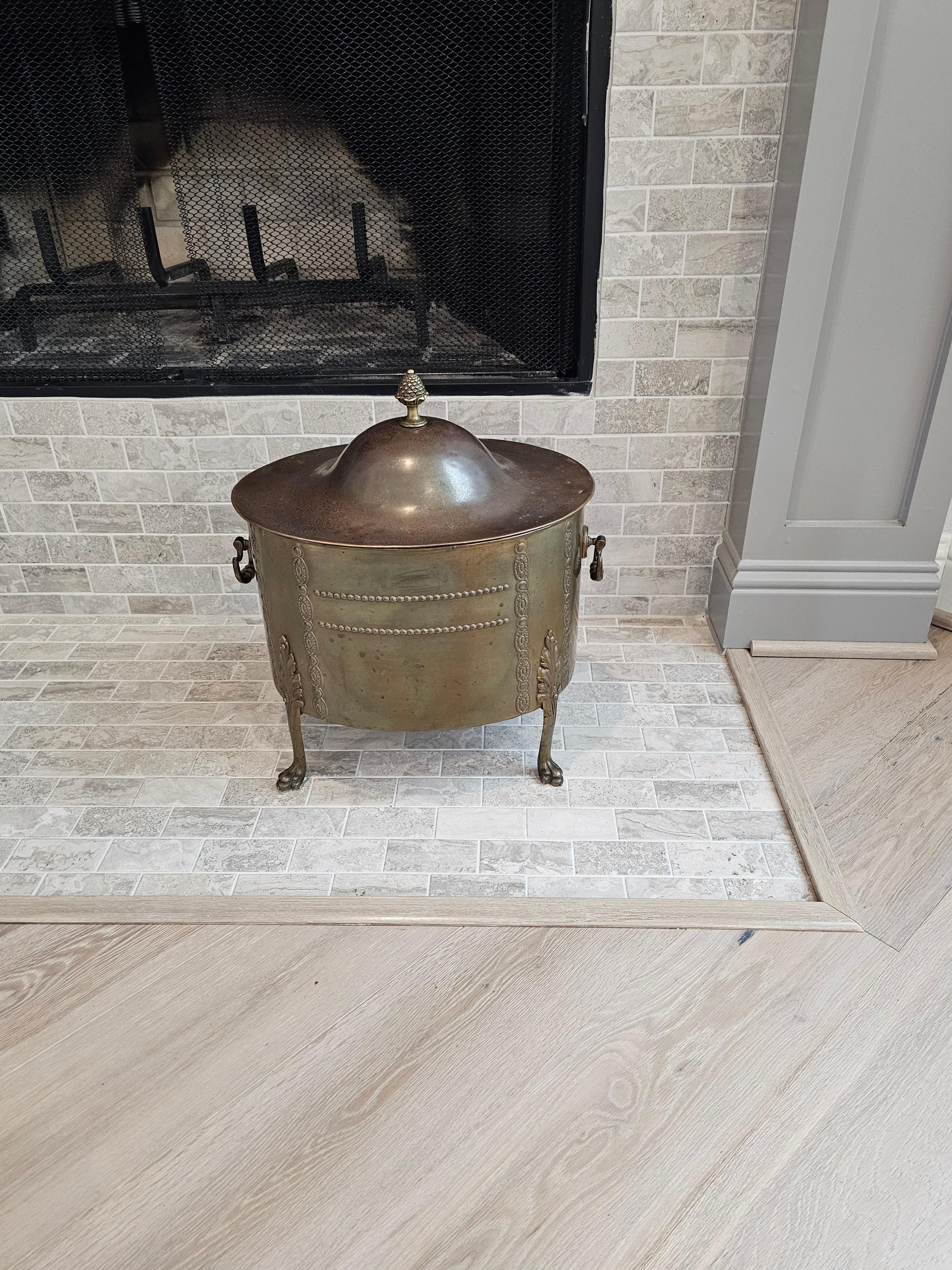 A charming Edwardian period brass lidded fireside coal scuttle (today it makes for a wonderful and functional fireplace accessory - kindling wood bin - hod - indoor planter)

Born in England in the early 20th century, featuring an oval lid