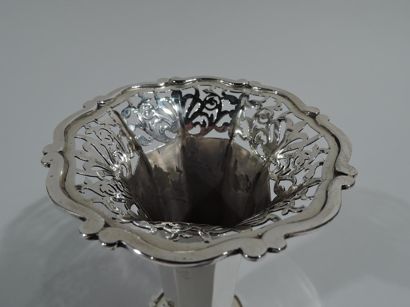 Edwardian sterling silver bud vase. Made by Goldsmiths & Silversmiths in London in 1906. Faceted and tapering on raised and faceted foot with scrolled rim. Mouth rim same with pierced ornamental band. Fully marked including design no. 349996.