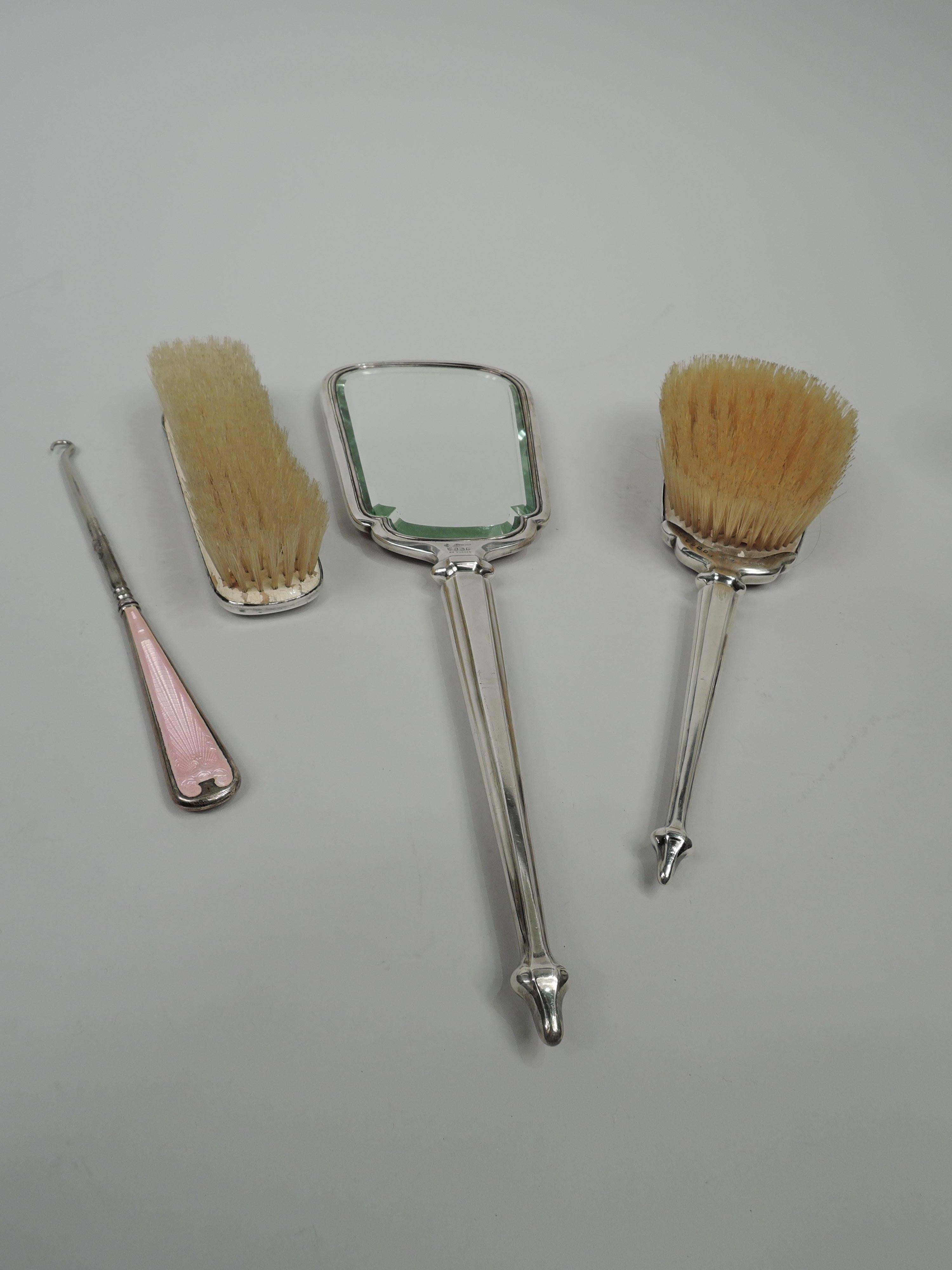 George V sterling silver and pink guilloche enamel vanity set. Made by Charles S. Green & Co., Ltd in Birmingham in 1927-8. This set comprises 4 pieces: Hand mirror, hairbrush, clothes brush, and button hook. Mirror and hairbrush have armorial backs