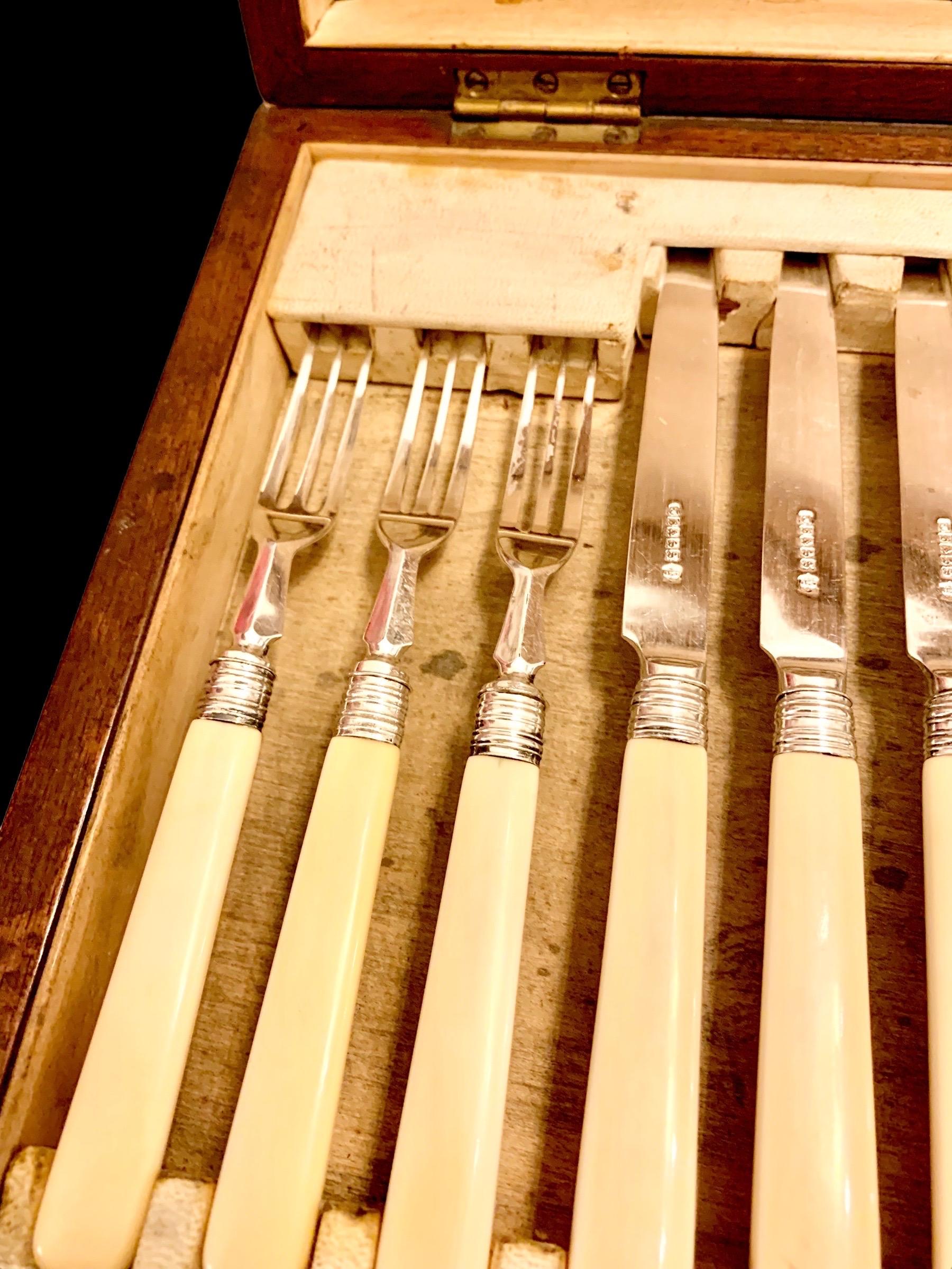 A lovely early 20th century Edwardian silver plate fish set with Bakelite handles, presented in a beautiful dark walnut box with lock. The knives showing hallmarks which I have not been able to identify. 

These are both beautiful and practical to