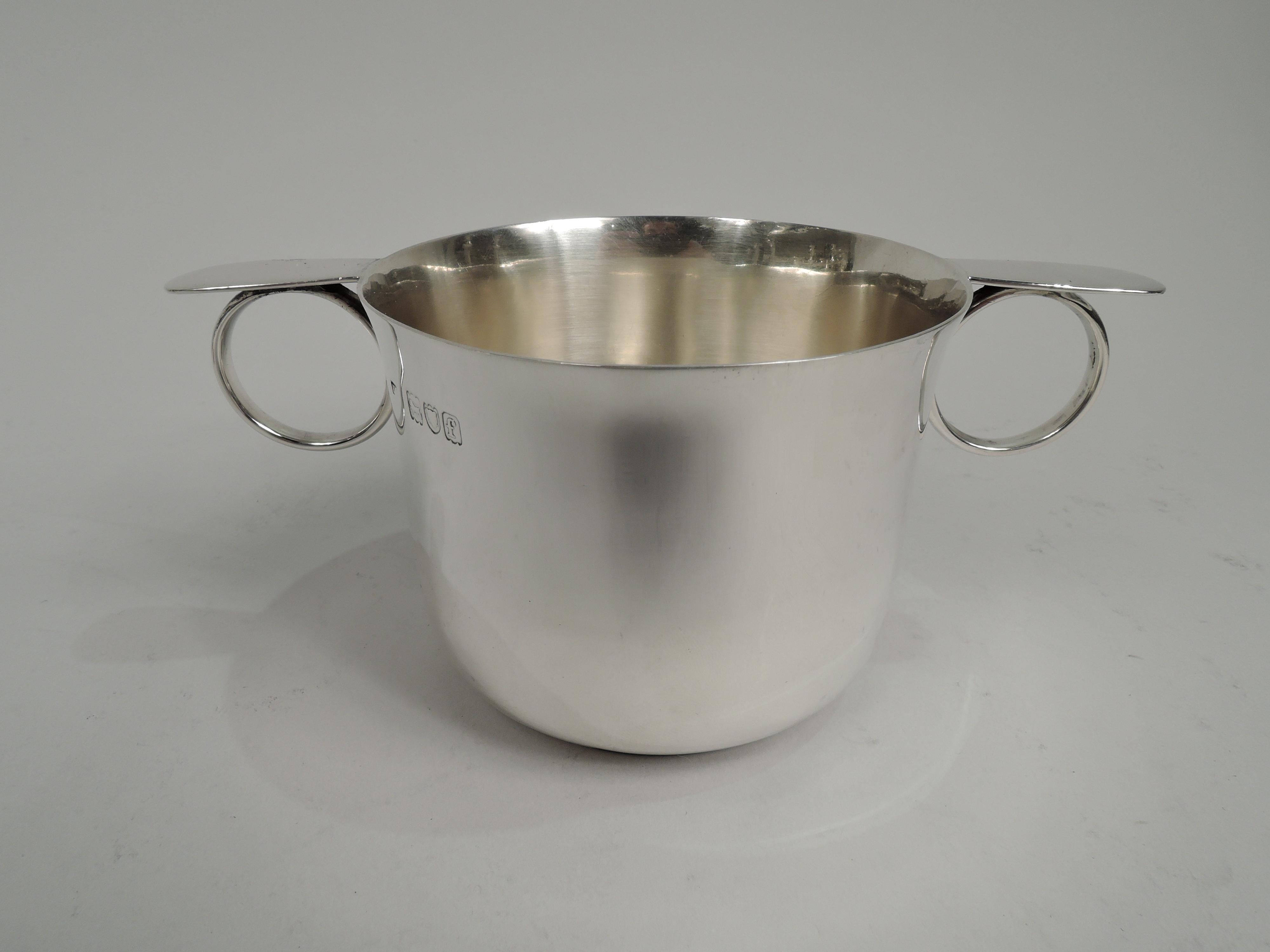 Edwardian sterling silver cup. Made by Henry Frazer in London in 1901.Round bowl with gently flared rim, curved bottom, and inset foot. Ring handles with flat and tapering caps. Fully marked including retailer’s stamp (“Rowlands & Frazer / 146