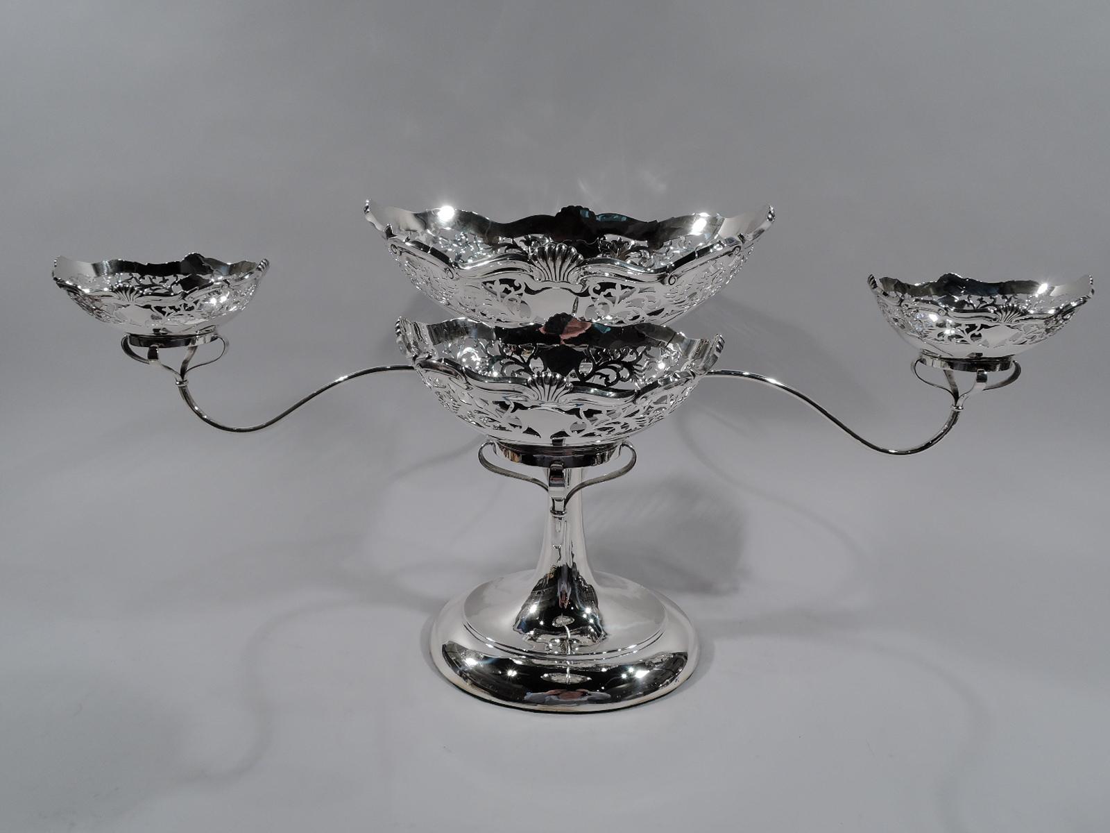 George V sterling silver epergne. Made by Williams in Birmingham in 1910. Slender oval shaft on large and stepped same foot. Shaft terminates in basket set in solid oval mount. Mounted to shaft are four scrolled arms each terminating in basket set