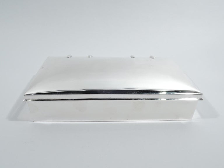 Edwardian sterling silver box. Made by Goldsmiths & Silversmiths Co. Ltd in London in 1905. Rectangular with straight sides. Cover has gently curved top, wrap around molding, and strap hinges. Box interior cedar lined. Fully marked. Gross weight: