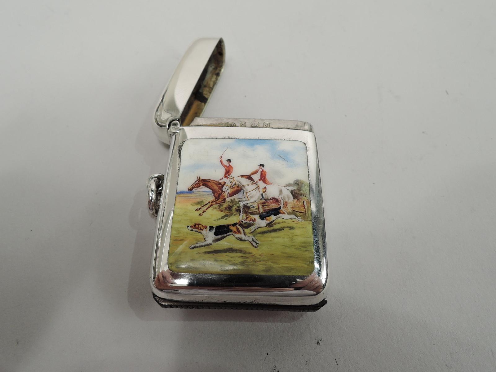 Edwardian sterling silver match safe. Made by Robert Chandler in Birmingham in 1905.Rectangular with hinged cover and curved corners. Bottom inset with strike. Loose-mounted ring. On front is enameled fox hunt scene with two riders taking a fence