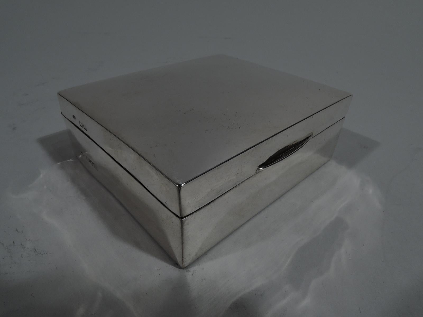 Edwardian sterling silver trinket box. Made by William Comyns in London in 1907. Rectangular with straight sides. Cover hinged, tabbed, and gently curved. Box and cover interior cedar lined. Box underside leather lined. Fully marked. Gross weight: 4