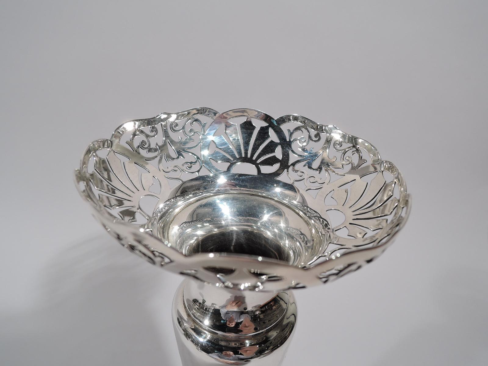 Edward VIII sterling silver vase. Made by Walker & Hall in Sheffield in 1936. Narrow and tapering body with base knop on gently raised and round foot. Spool neck and hemispheric rim with pierced scallop shells and scrollwork. Fully marked. Weighted.