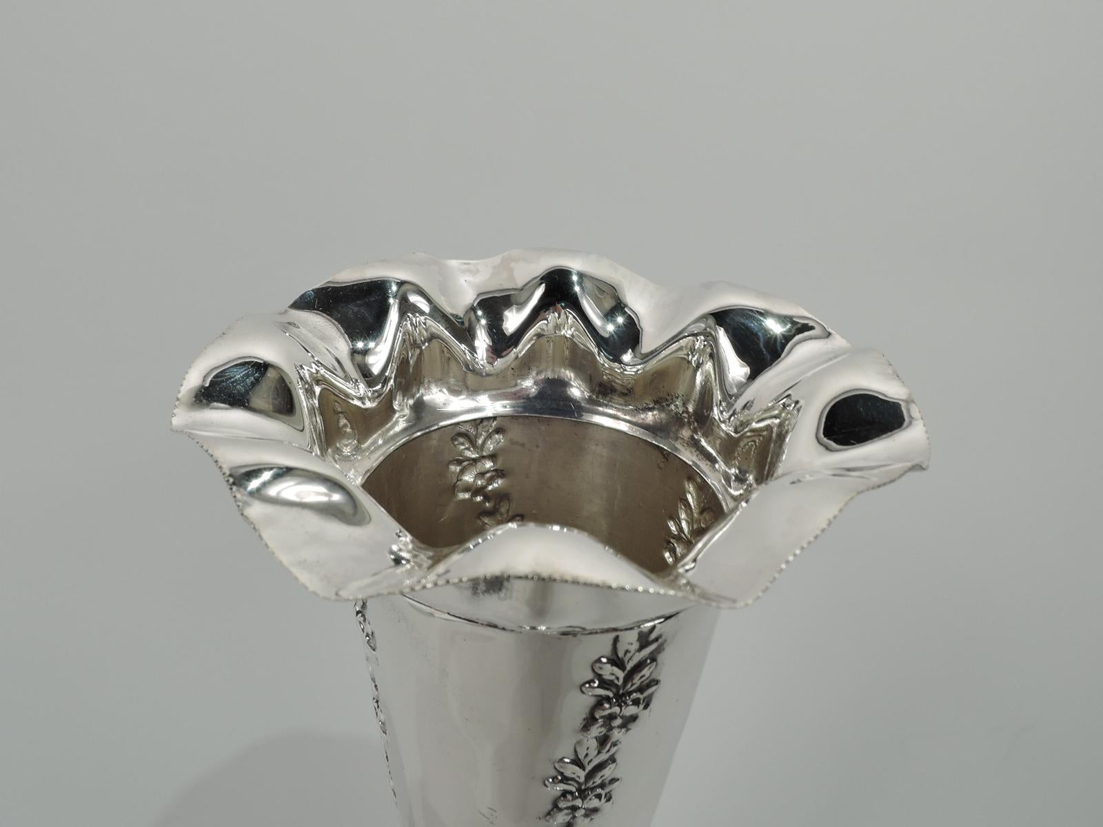 Edwardian sterling silver vase. Made by Alexander Clark Mfg. & Co in Birmingham in 1904. Conical with ruffled rim and round and stepped foot. Twisted fluting in form of chased garlands. Fully marked. Weighted.
