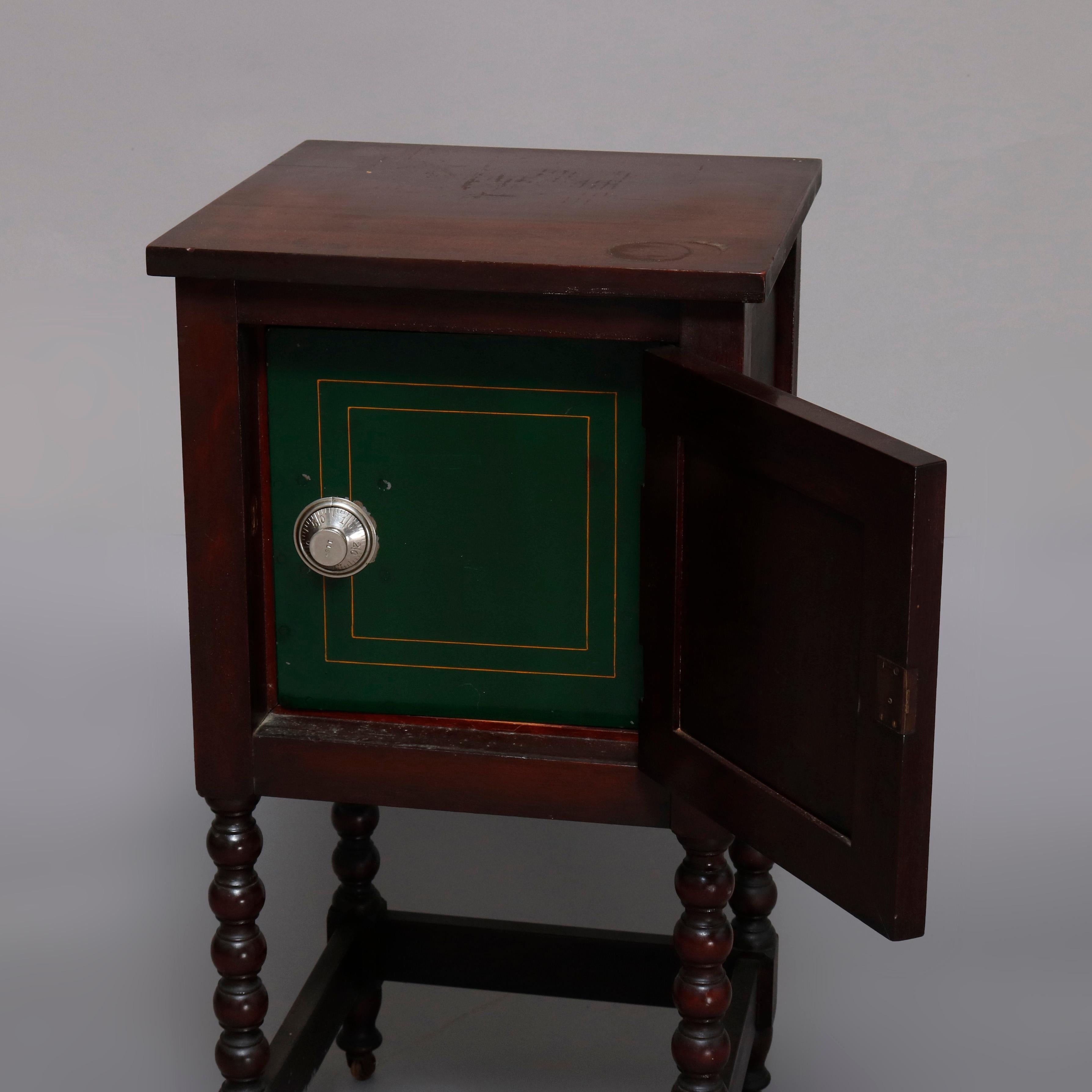 An antique English Edwardian style cabinet safe offers mahogany construction with upper single door cabinet opening to reveal combination safe, raised on carved bobbin legs terminating in casters, circa 1920

Measures: 31.5
