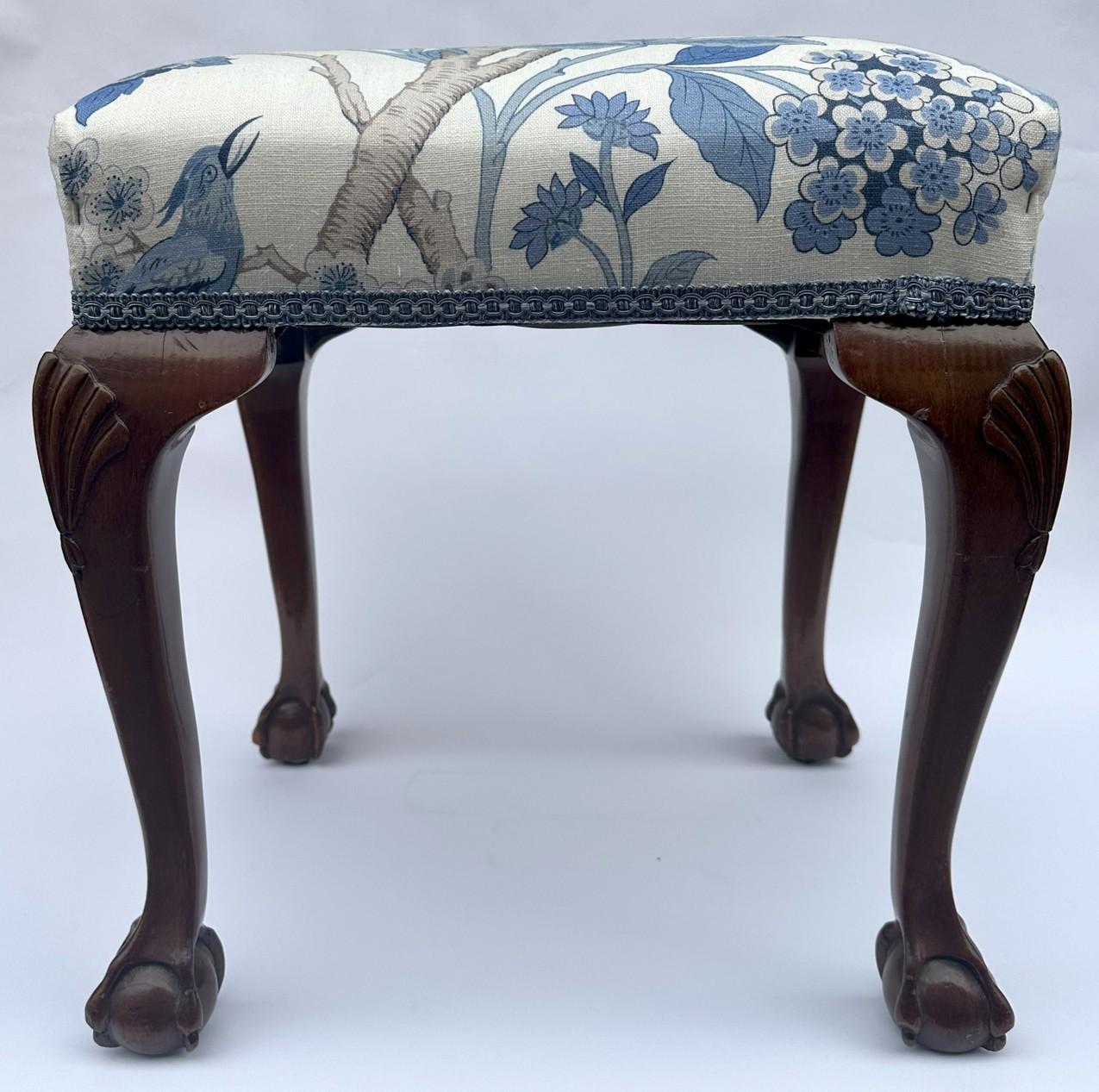 Stylish Hand Carved Edwardian solid Mahogany frame upholstered Stool of rectangular form and of English origin. Circa first quarter of the Twentieth Century. 

Constructed in figured mahogany, the rectangular seat above an attractive hand carved