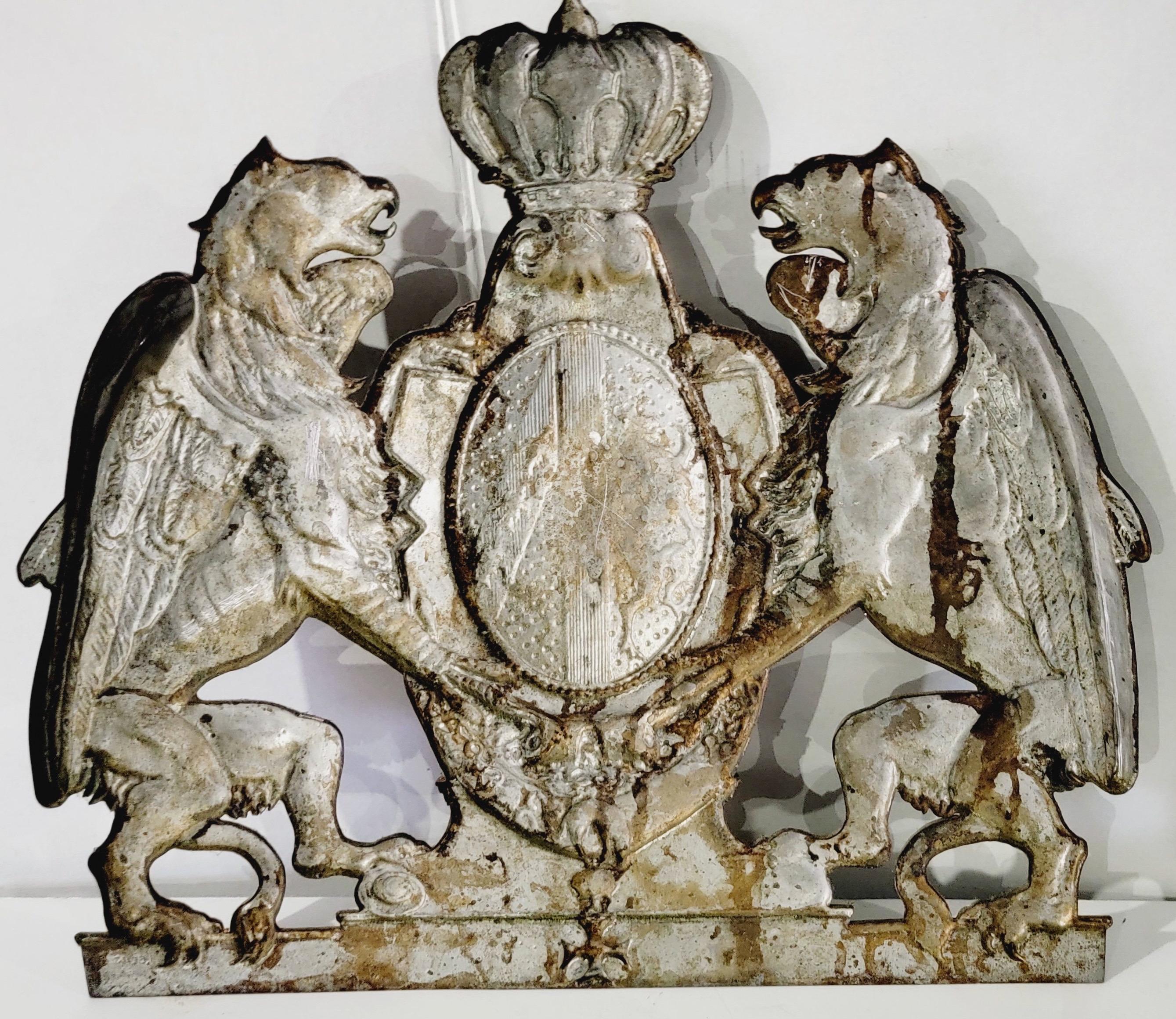 This is an antique English embossed armorial wall plaque in very good condition. What a great look! It depicts two lions supporting a shield under a crown.