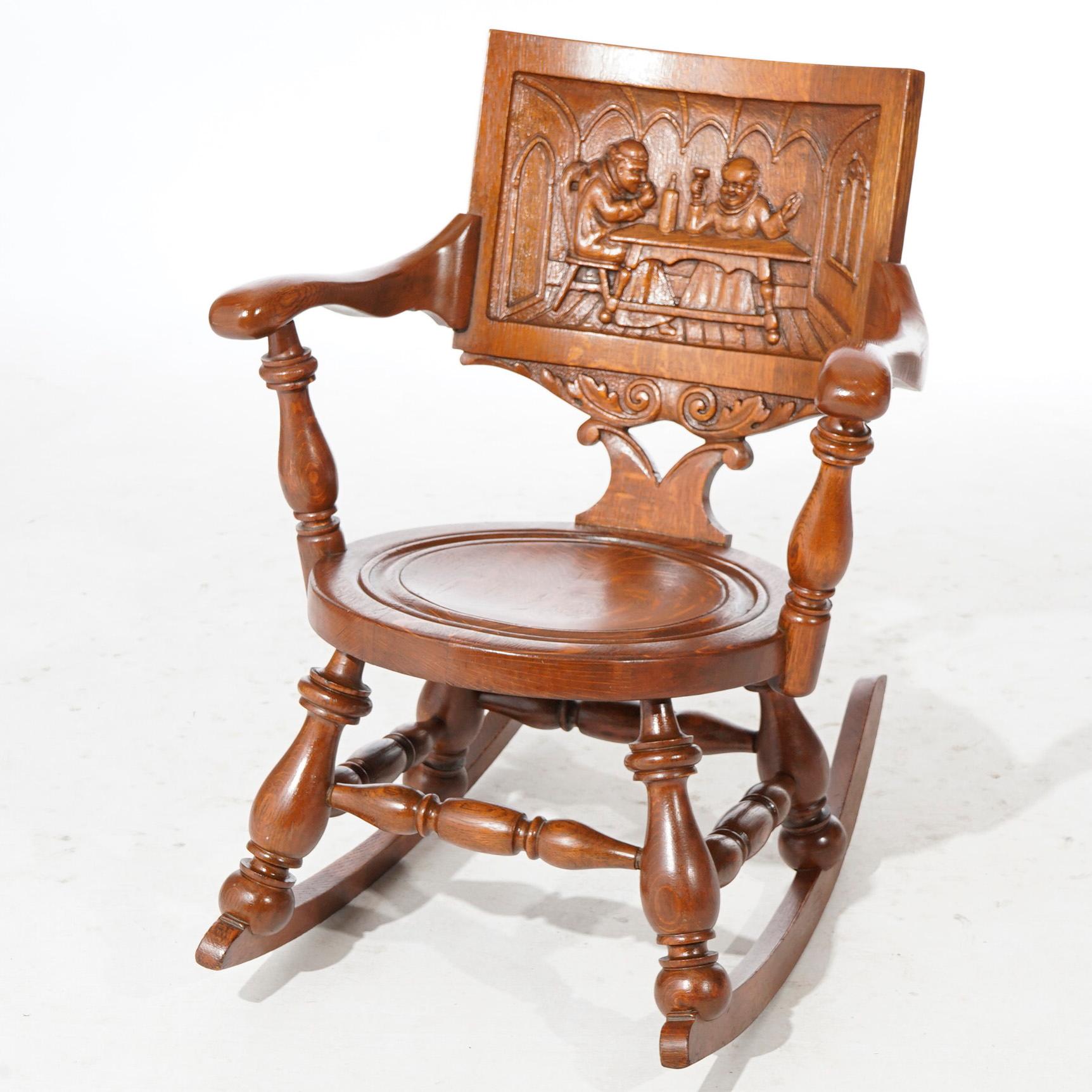 An antique English rocking chair offers oak construction with carved genre pub scene in back, turned balustrade supports and carved foliate elements, c1910

Measures- 32.25'' H x 25.25'' W x 30.5'' D; 15.5'' seat height.

*Ask about DISCOUNTED