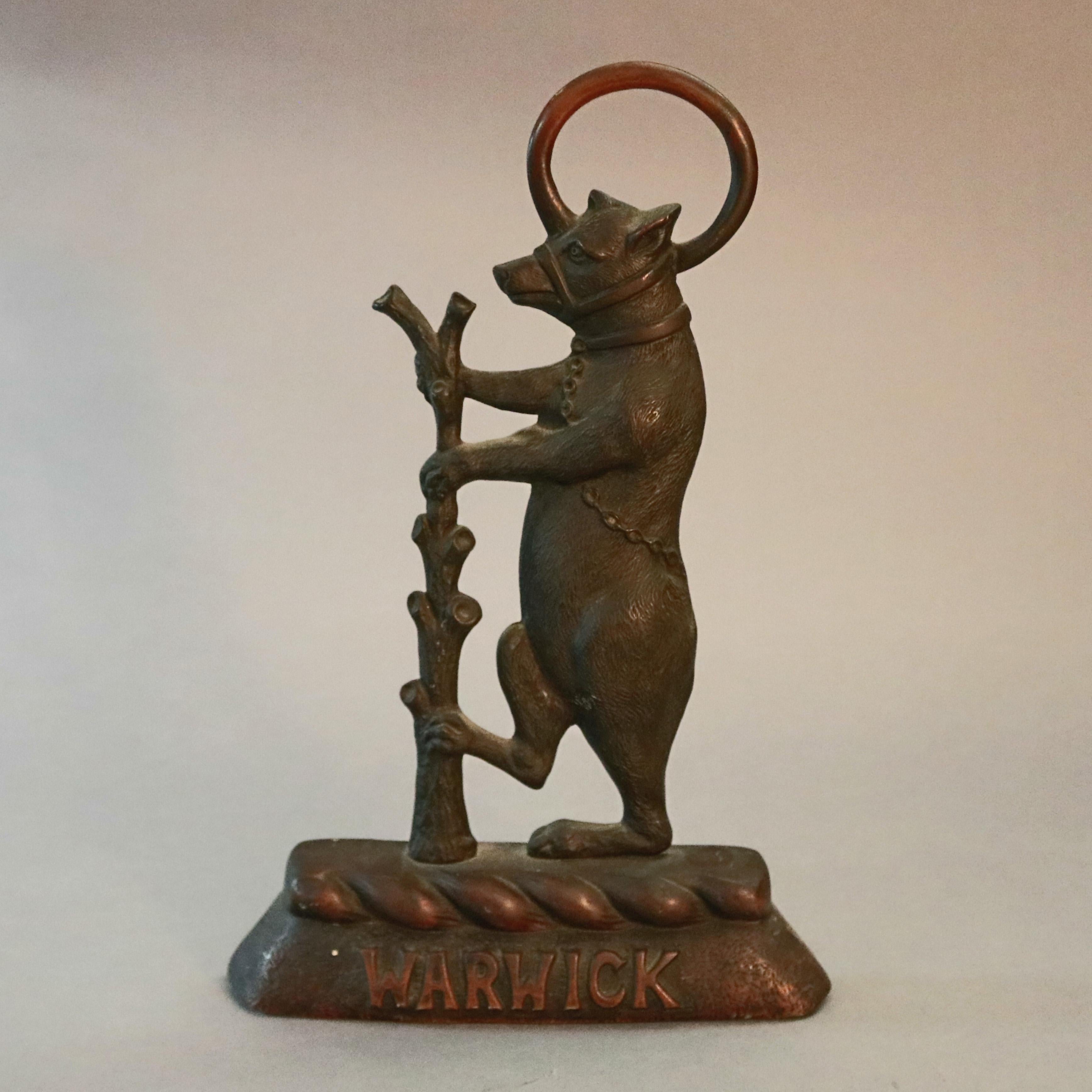 An antique English figural door stop offers cast bronze sculpture of Warwick Bear (bear and ragged staff) on base embossed with 