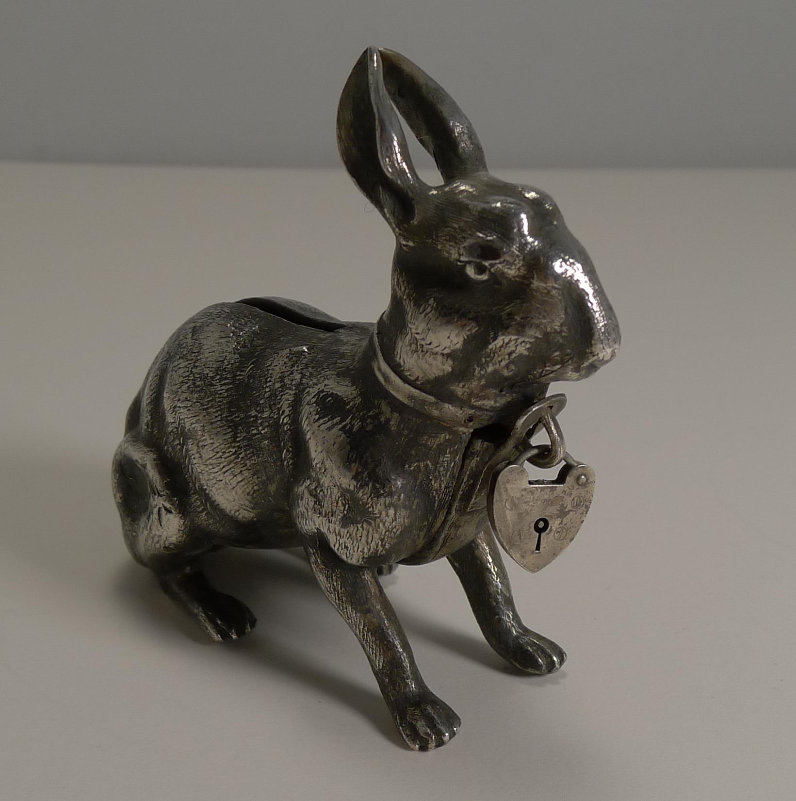 A highly sought-after and scarce little money box or bank in silver plate with a fabulous antique patina.

The box was made in the from of a Hare or Rabbit with a heart shaped lock to the front (these don't actually lock), the lock opens and snaps
