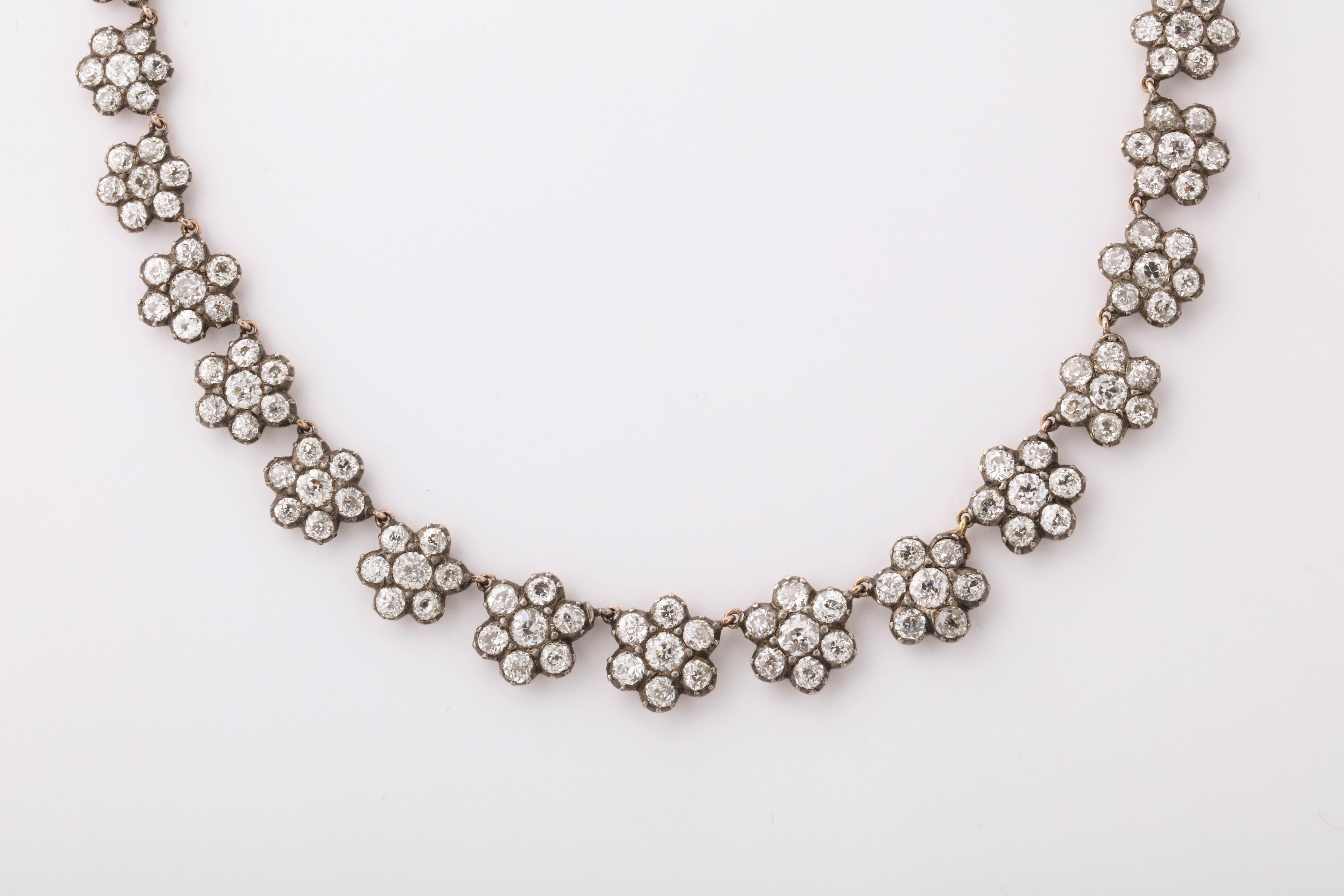 Made in London c.1900 by the famous firm Parkes of Vigo Street. The firm was known for making exquisite Georgian revival jewelry. This necklace is in the Georgian style with the diamonds set in closed back settings in silver over 15K yellow gold.