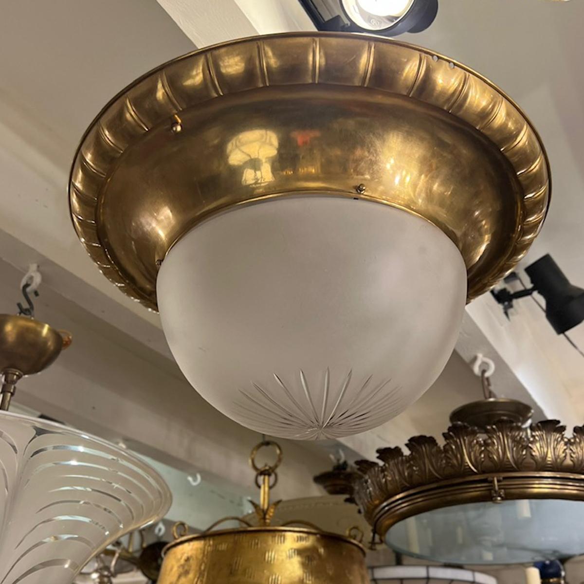 A circa 1920's English gilt bronze flush mounted light fixture with frosted glass inset.

Measurements:
Height: 10