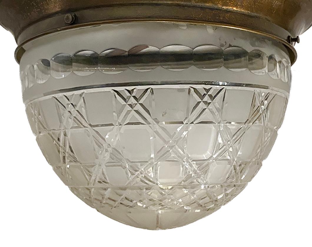 A circa 1920s English repoussé brass flushmounted light fixture with etched glass inset.

Measurements:
Diameter 14