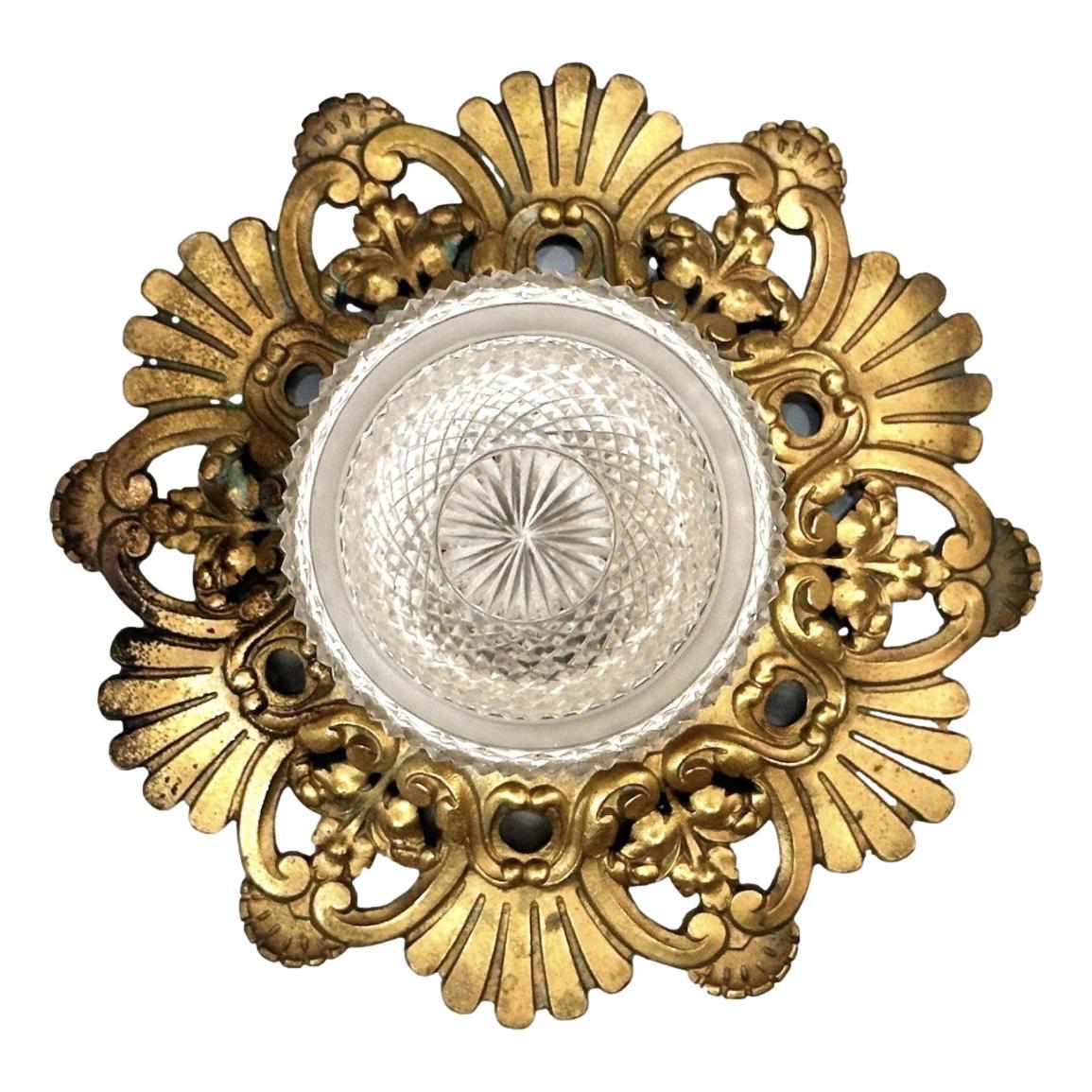 A circa 1920's English bronze flush-mounted light fixture with molded and cut glass.

Measurements:
Drop: 9.5