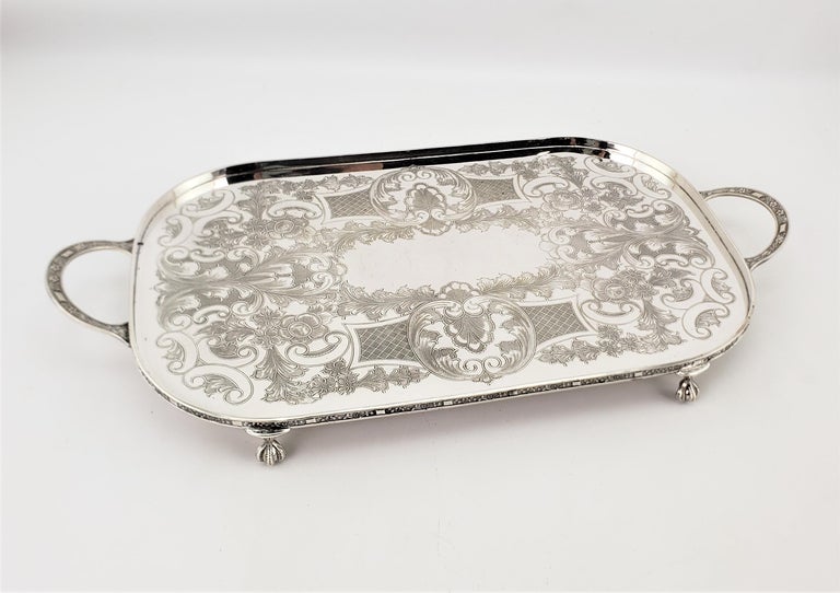 This small and well made silver plated serving tray was made by Viners of Sheffield England in approximately 1900 in a period Edwardian style. This tray has a low gallery which has been nicely decorated with a leaf pattern, which is replicated on