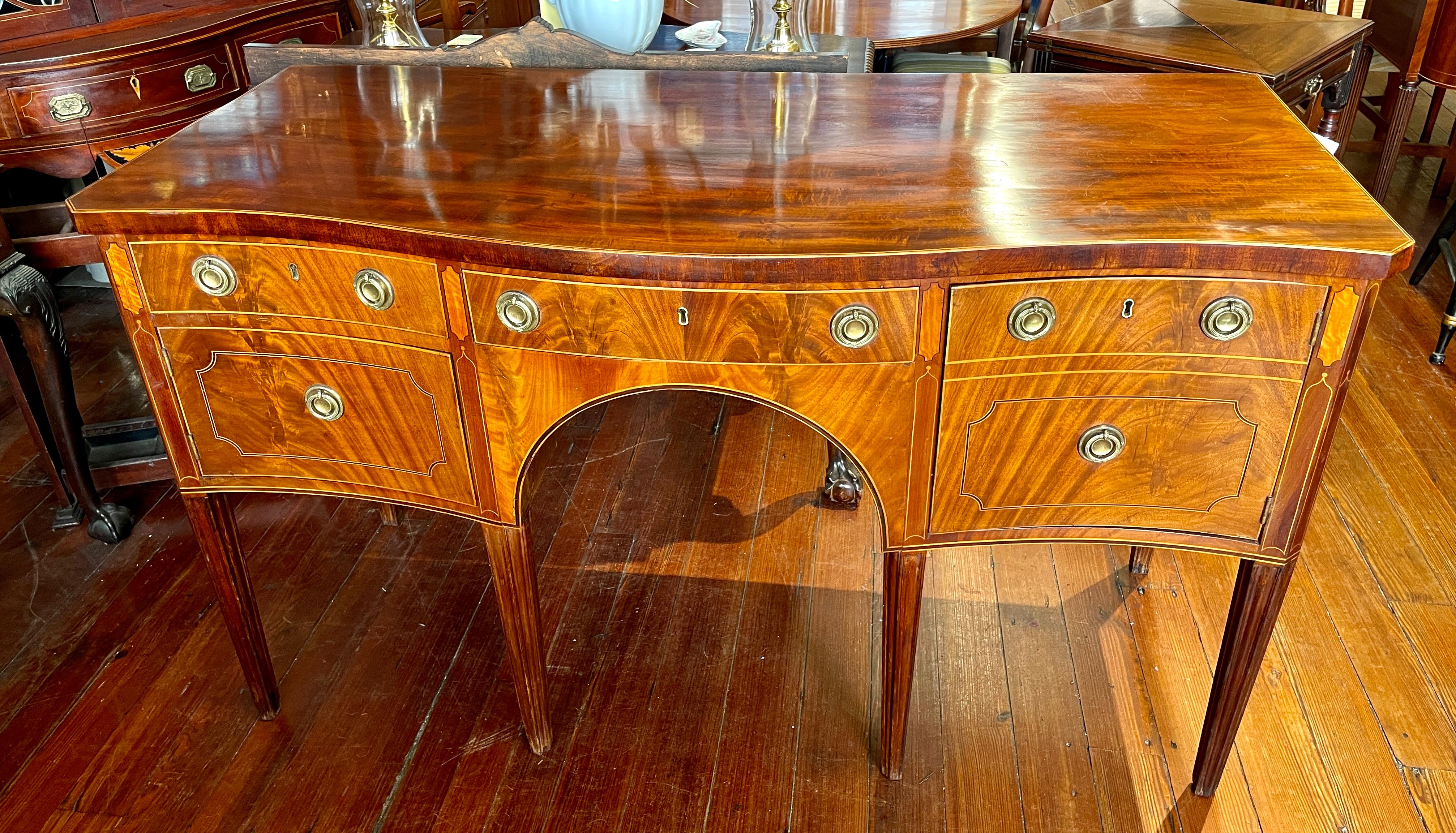 Extraordinarily Fine Antique English PERIOD Geo. III Inlaid bookmatched flame or crotch mahogany Hepplewhite style serpentine Sideboard with exceptional satinwood and boxwood inlays throughout (see images).  The brasses are antique.  There appears