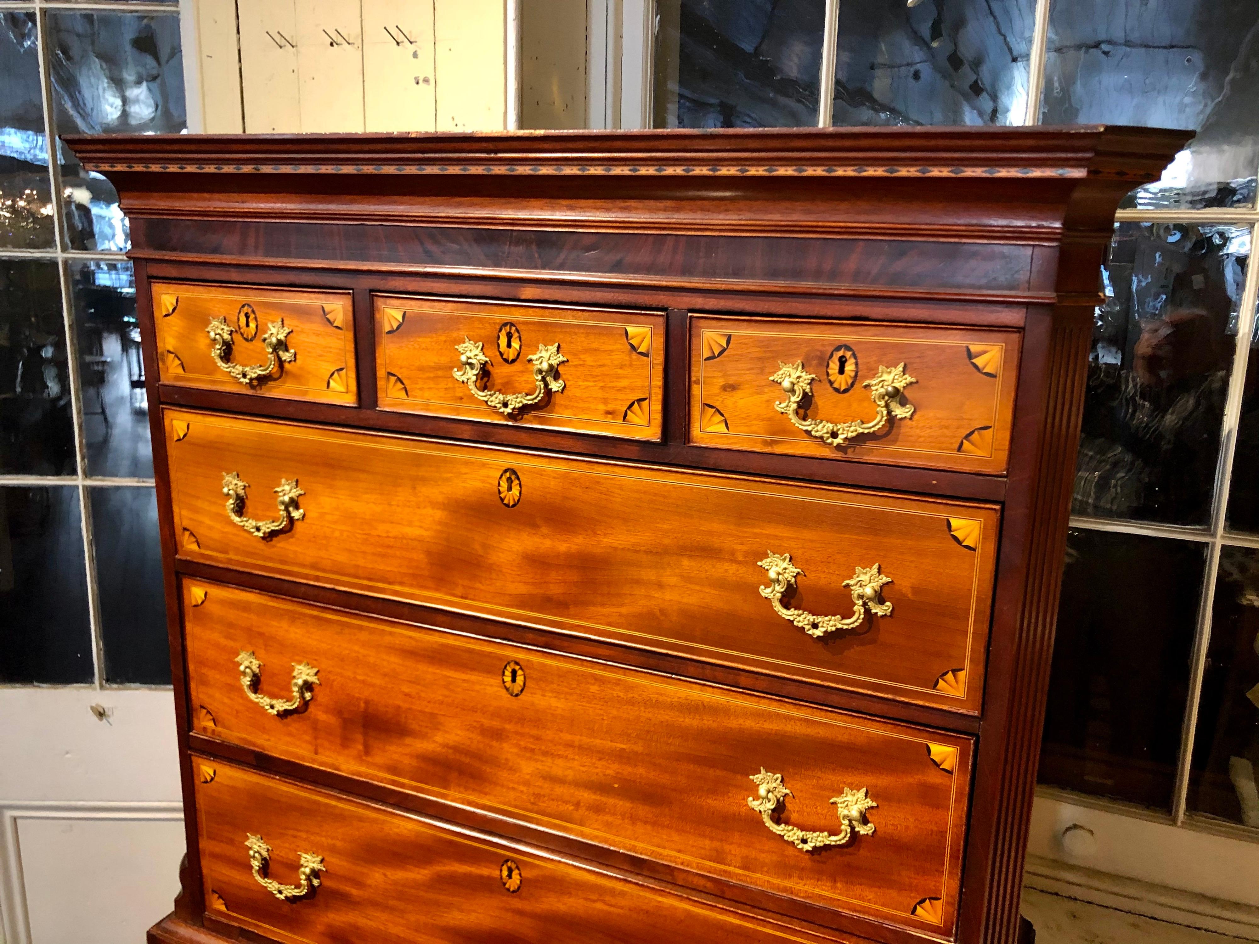 One of the finest quality Antique English Geo. III period inlaid figured mahogany Chippendale style Chests on Chests or Tallboys we have had in years. With superlative marquetry inlays of satinwood quarter fans on the perimeter of each drawer as