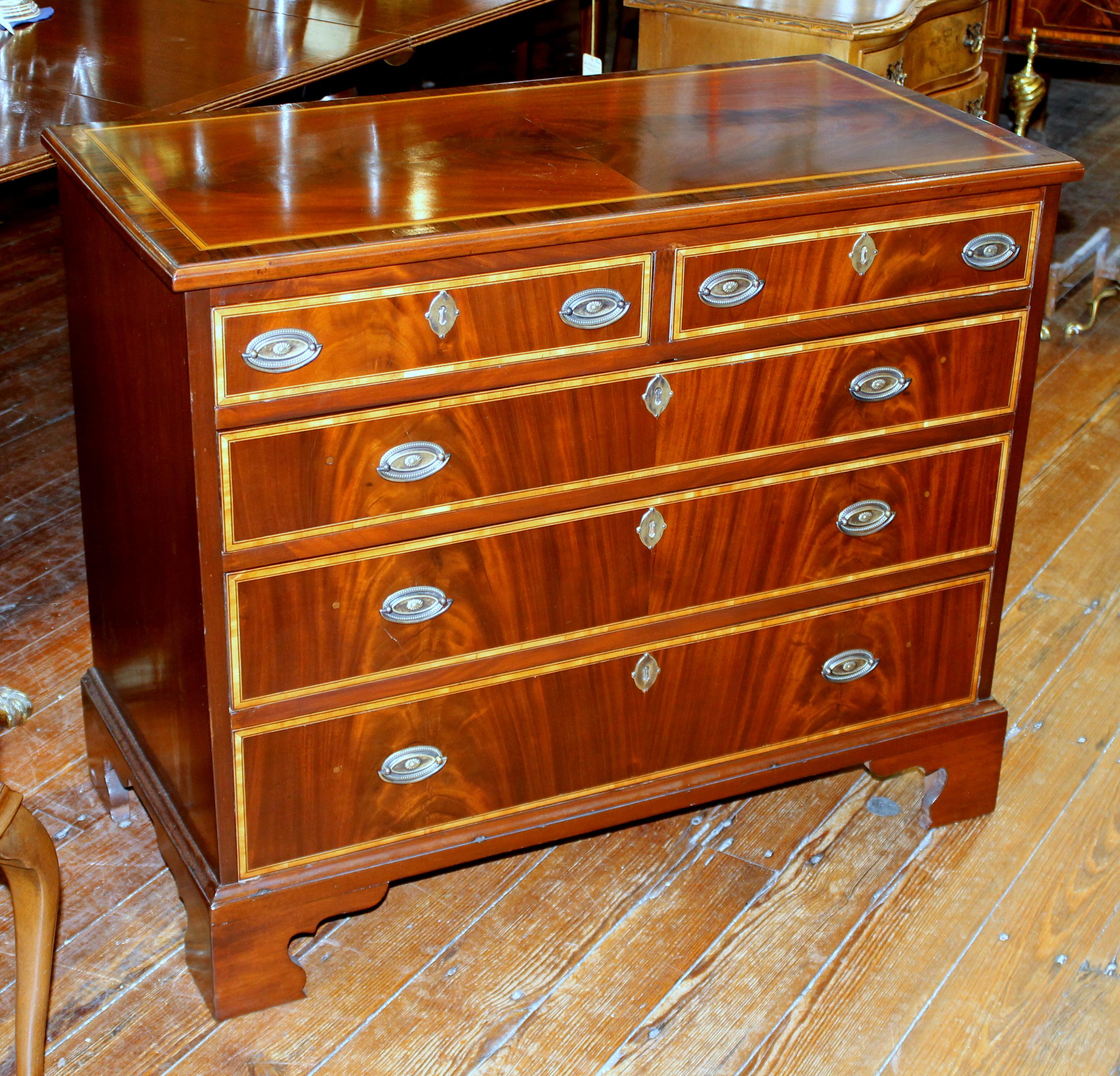 Fabulous quality antique English George III inlaid flame mahogany rare diminutive size low chest of drawers with magnificent book-matched crotch mahogany. Even the top is beautifully book-matched quartered and veneered flame mahogany.

Please note