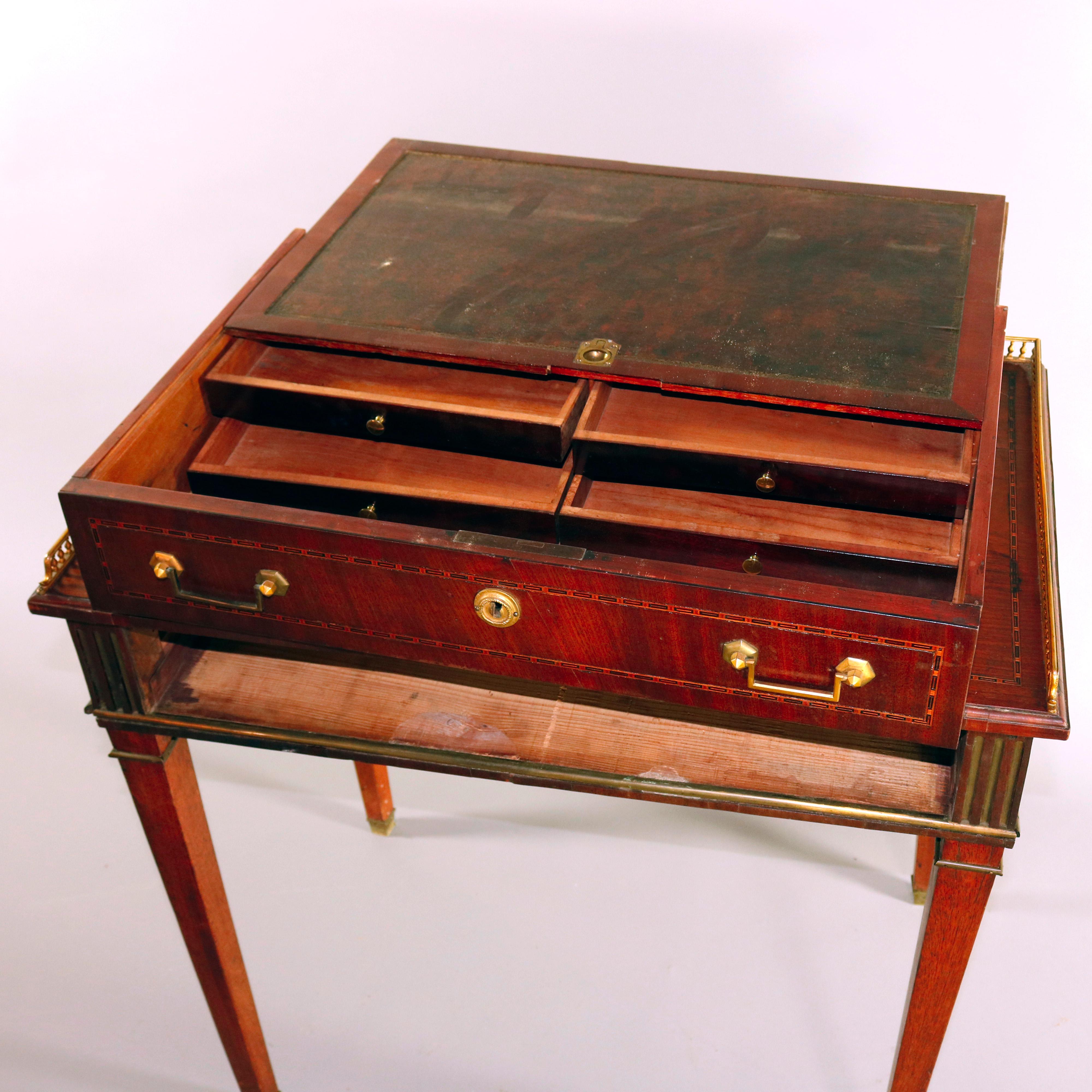 An antique English George III kneehole writing desk feature mahogany construction with frieze drawer opening to reveal leather top writing surface and multiple interior compartments, satinwood and ebonized banding throughout and oval inlaid reserve,