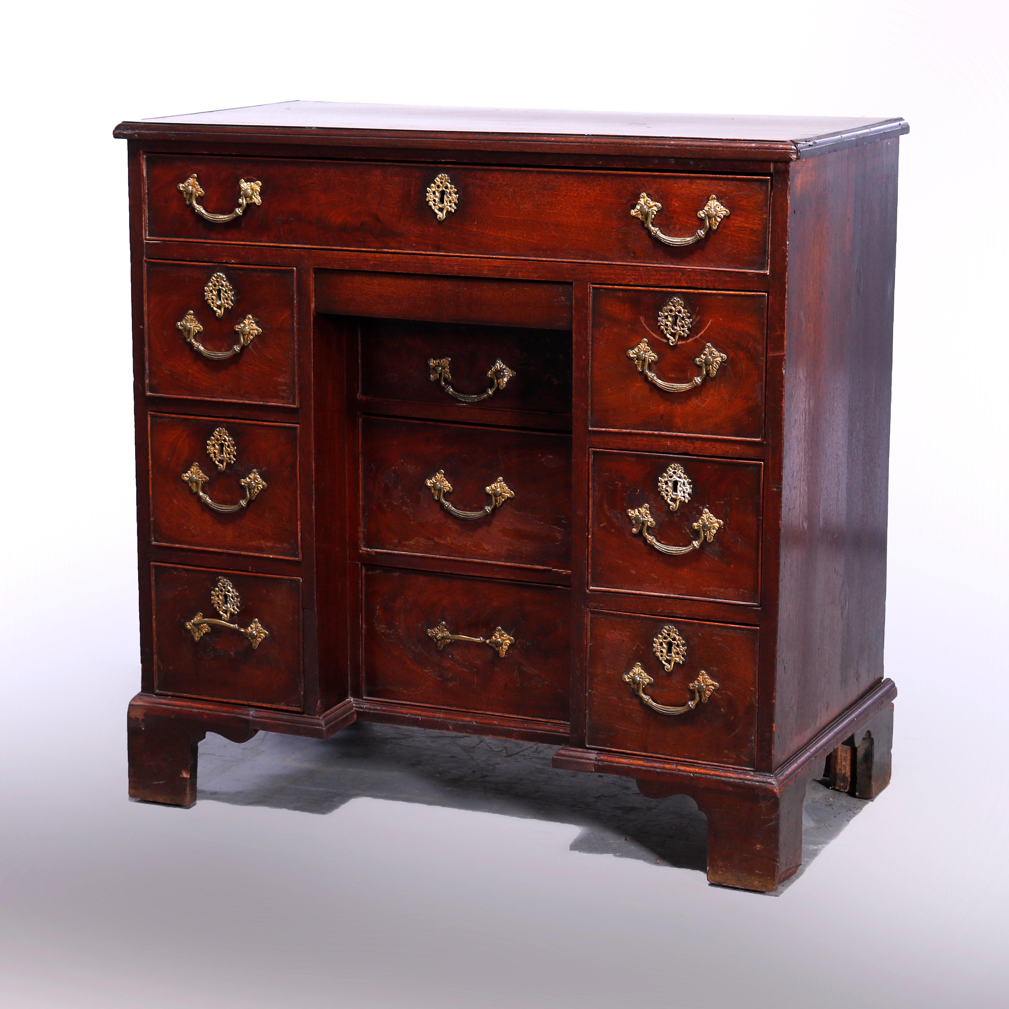 An antique English George III bachelor's chest offers mahogany construction with beveled top over three drawer towers, one recessed with others flanking, raised on bracket feet, c1830

Measures - 32.5'' H x 33'' W x 17'' D.