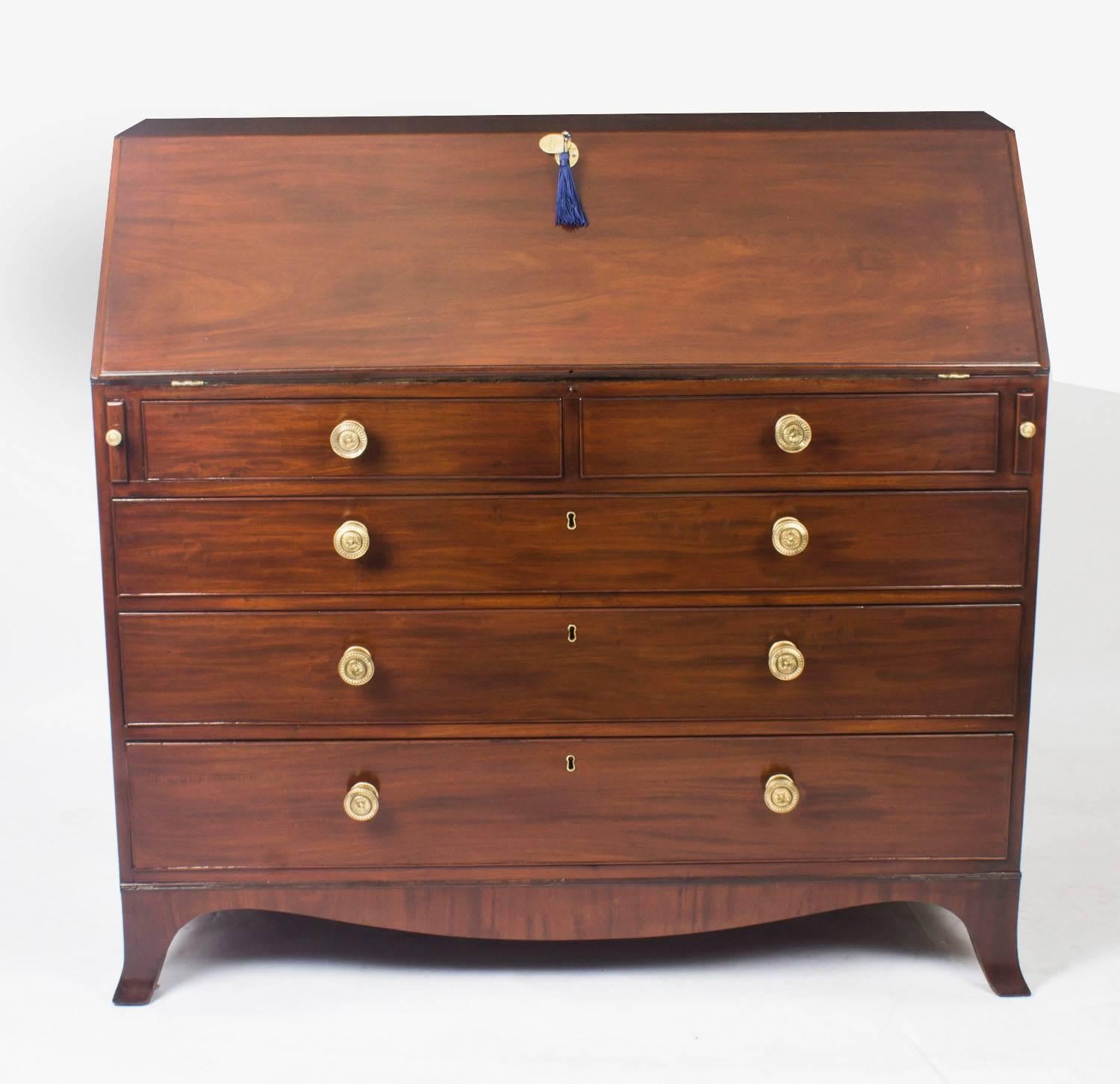 This antique bureau is late 18th century in date and has been beautifully crafted from top quality flame mahogany. The design is quite simple yet it has managed to make maximum use of the fine grain of the mahogany which is beautiful and has a