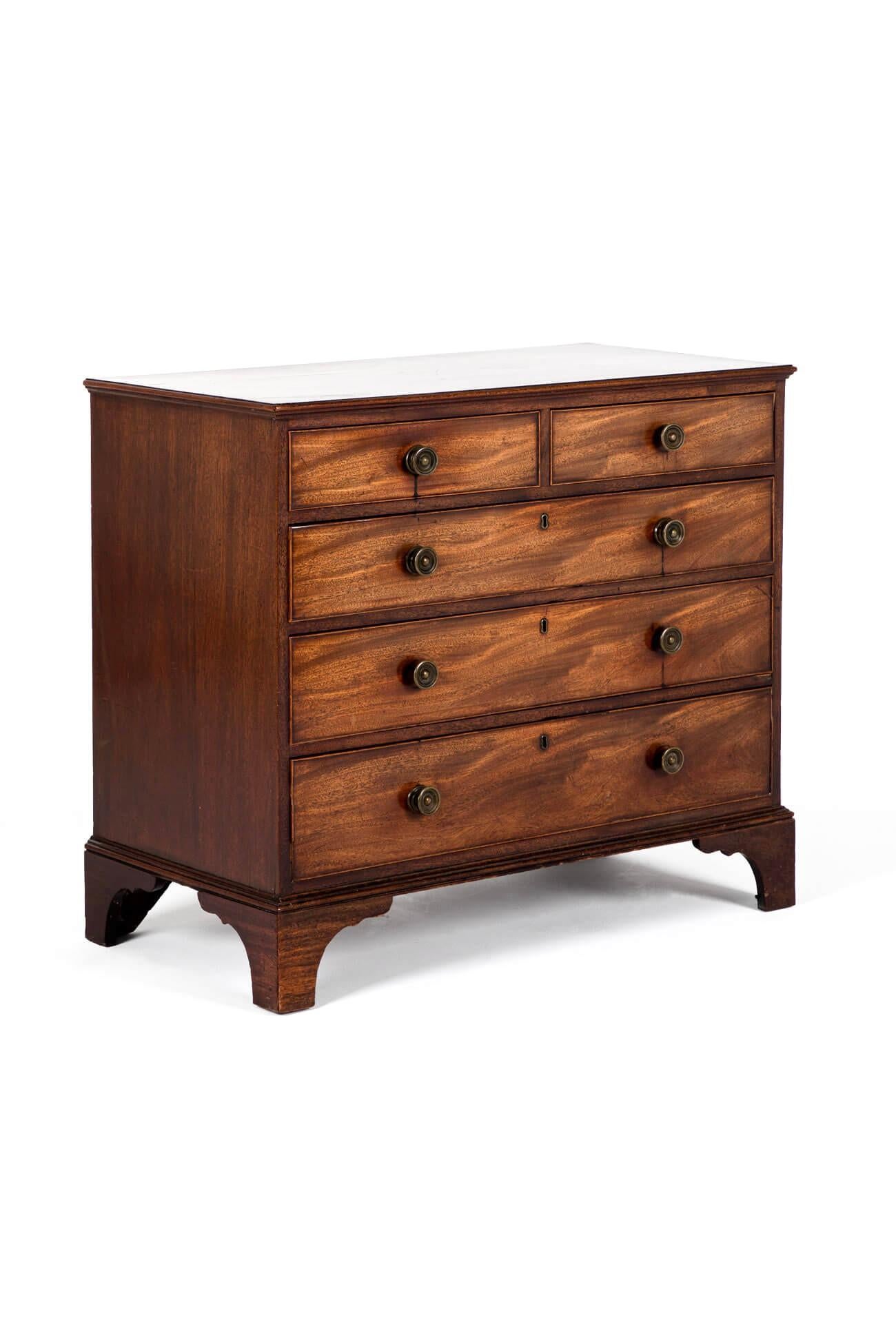 A period George III mahogany chest of drawers with an arrangement of two short over three long drawers.

The cockbeaded drawers retain shapely brass drawer pulls on a skirted base raised on bracket feet.

This excellent piece of Georgian furniture