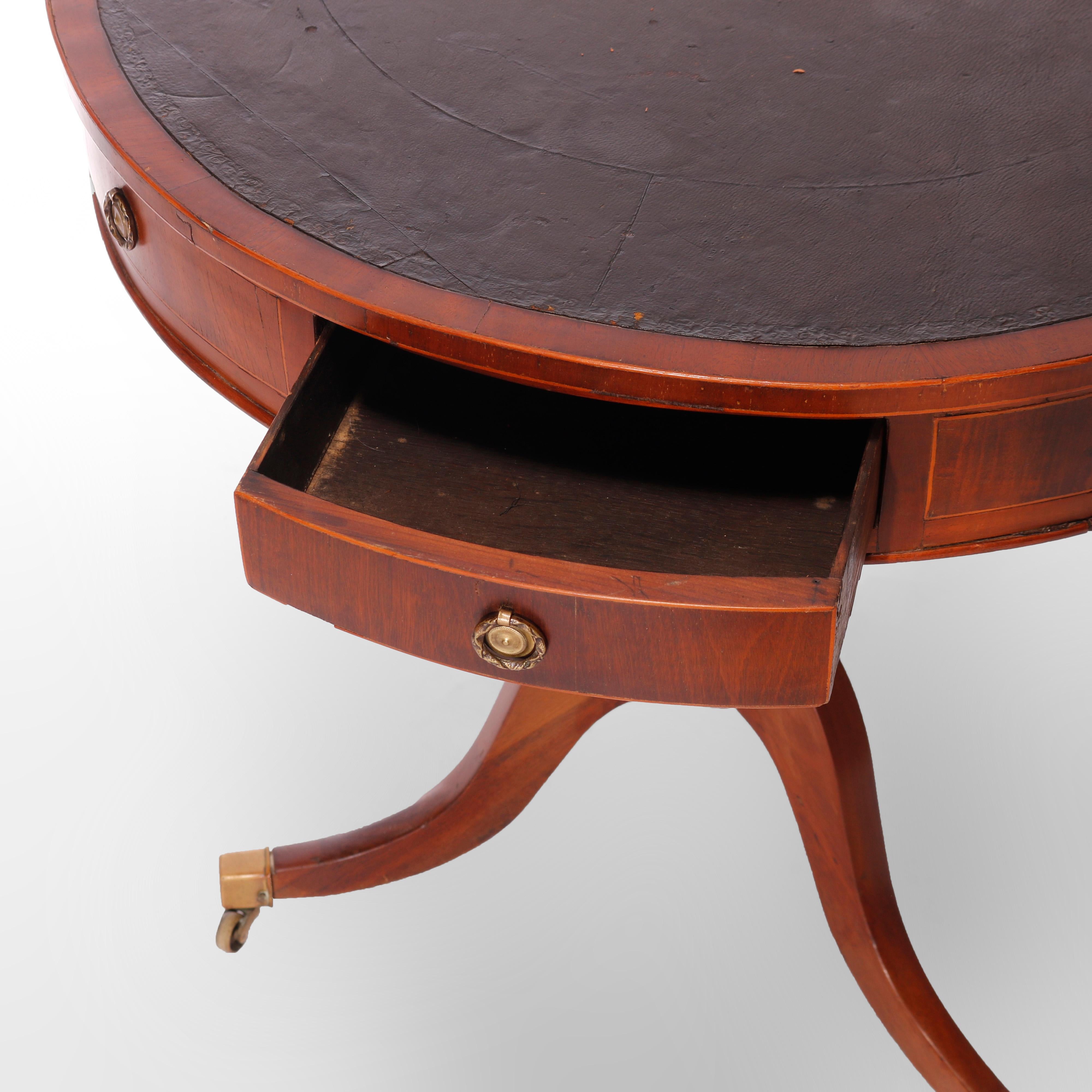 ***Ask About Reduced In-House Shipping Rates - Reliable Service & Fully Insured***
An antique English George III drum game table offers mahogany construction with leather top, single drawer, turned column and raised on cabriole legs,