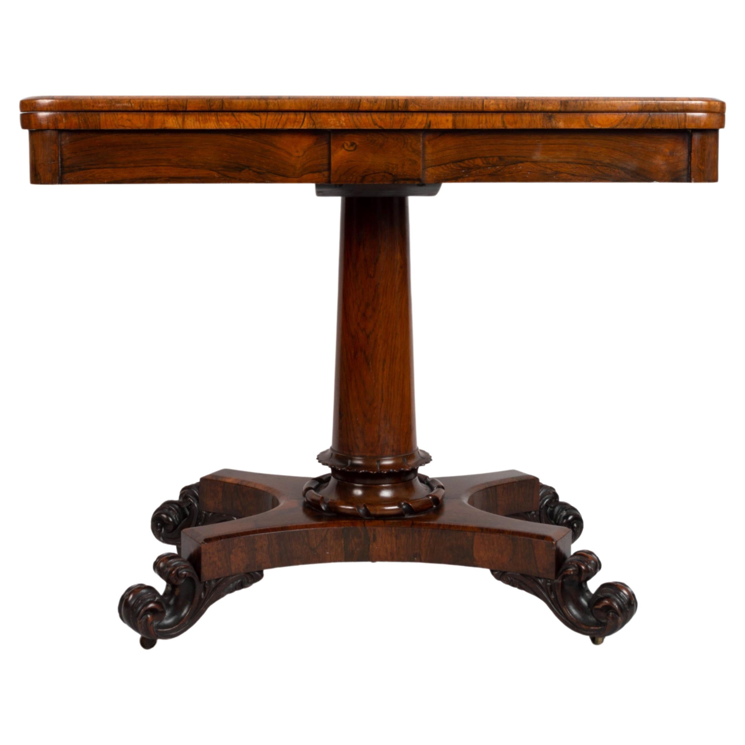 Antique English George IV rosewood card table by James Winter London, C.1825

A Georgian pedestal card table in beautifully figured rosewood throughout and
with a dark pink circular baize lining. A lapit carved base to the column, on a shaped