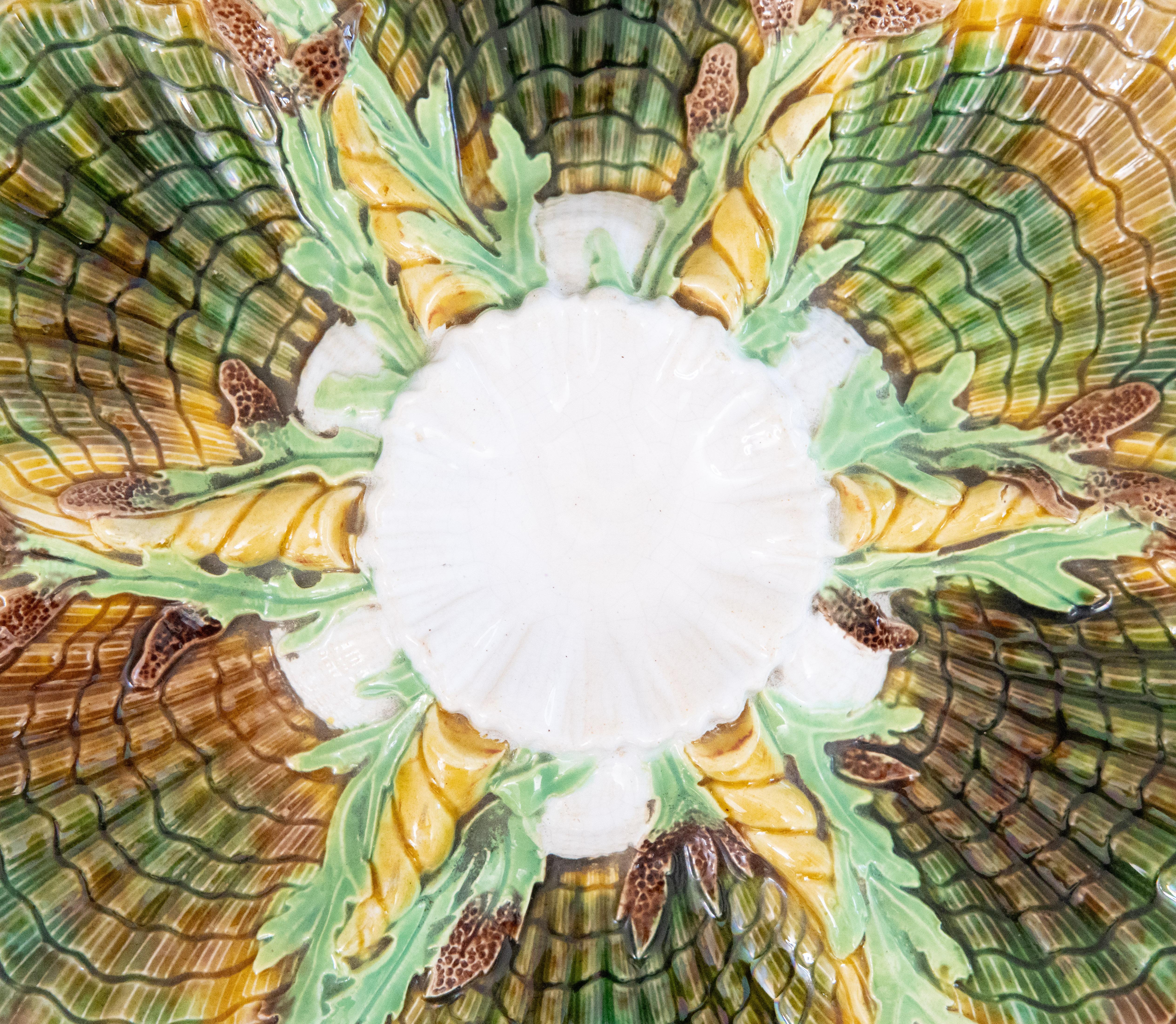A stunning antique English George Jones majolica glazed green, ochre, brown, and white oyster plate with central well surrounded by shells and seaweed. Pattern number to reverse (3589) and impressed letter 'D' for 1878. It displays beautifully - a